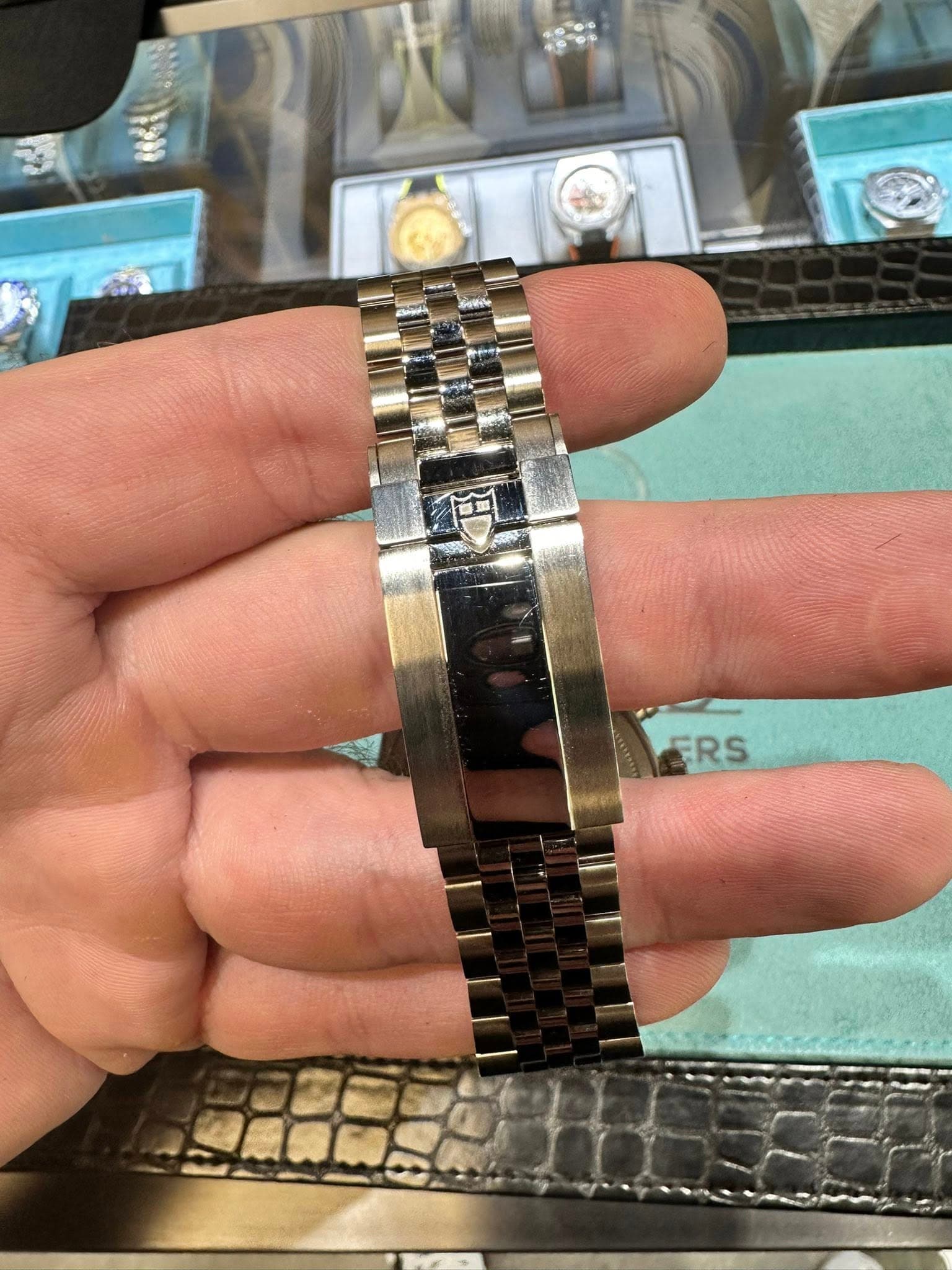 May be an image of wrist watch, jewelry and text