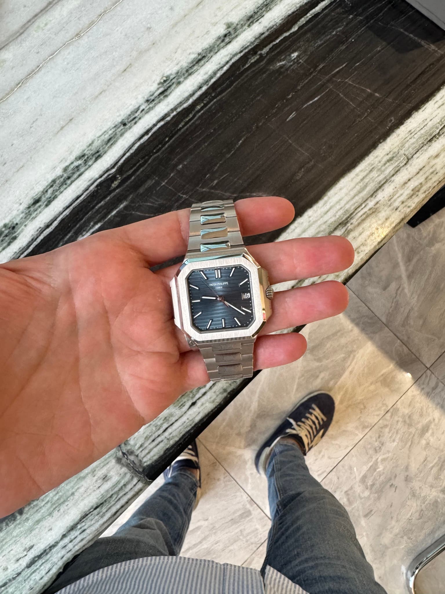 May be an image of 1 person, wrist watch and text