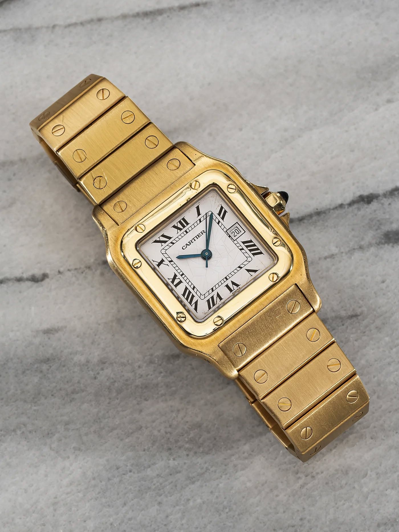 May be an image of wrist watch and text that says 'O O O D KII X CARTIER O I 27 T O IX II IA S 1 19 C'