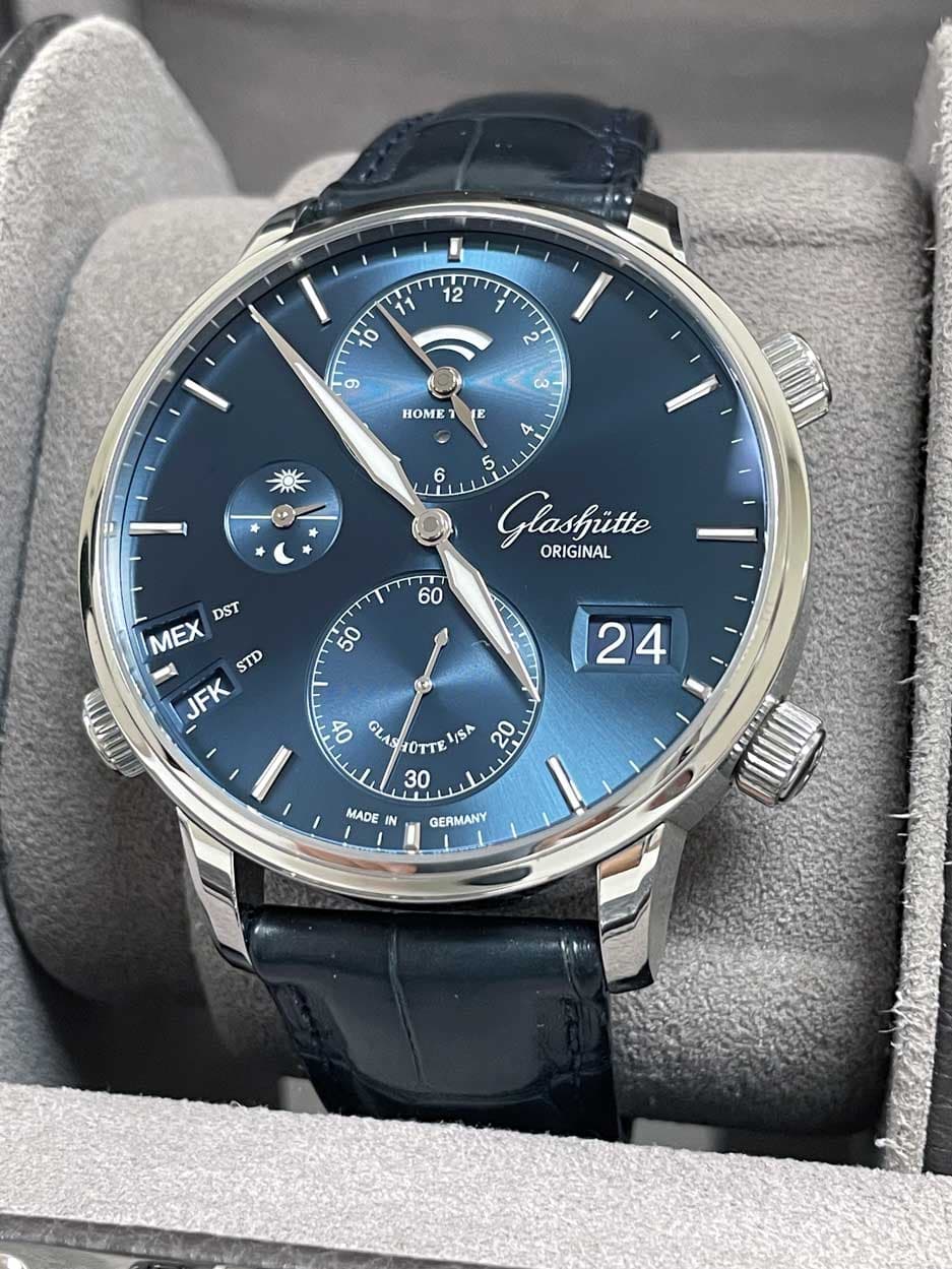 May be an image of wrist watch and text that says 'TT 12 10 2 တ ش دن ١ HOME 7 E 4 6 5 Glasfitte ORIGINAL 60 DST MEX 3 STD JFK 50 サ 24 4 2 0 GL OTT ISA /SA 20 30 MADE IN…