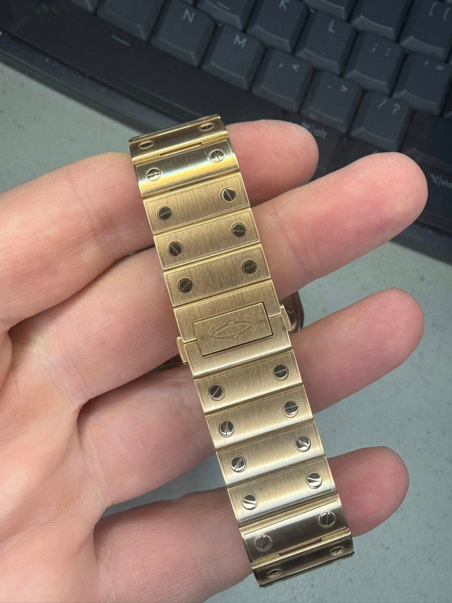 May be an image of wrist watch and brass