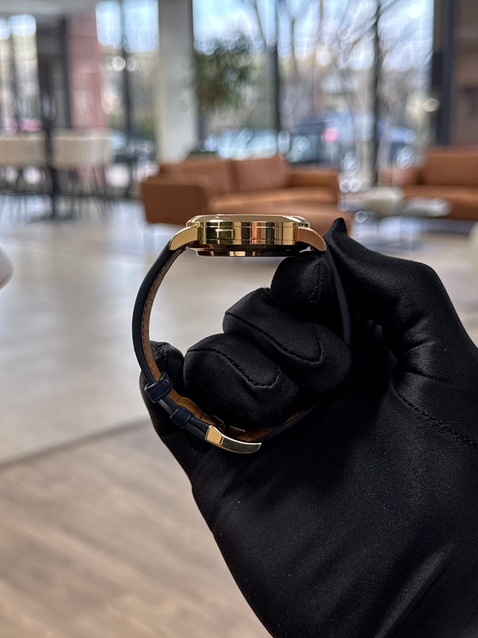 May be an image of wrist watch, leather and jewelry