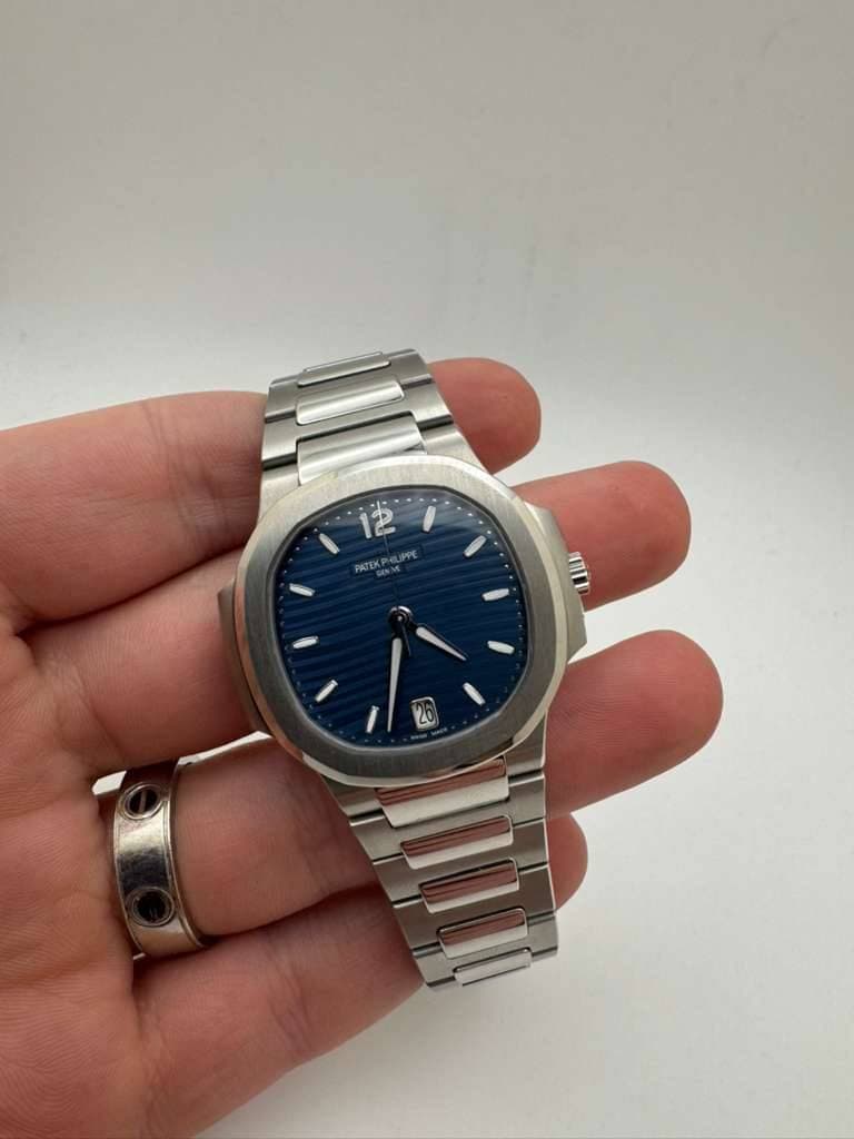 May be an image of wrist watch and text