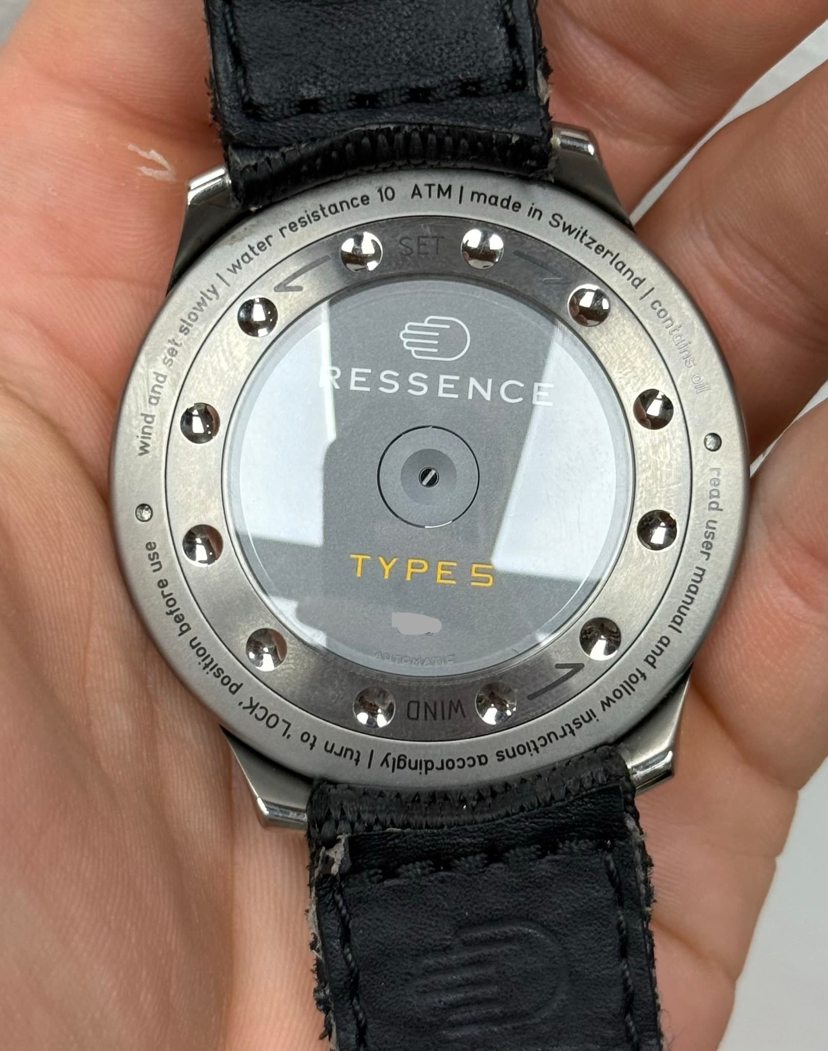 May be an image of wrist watch and text