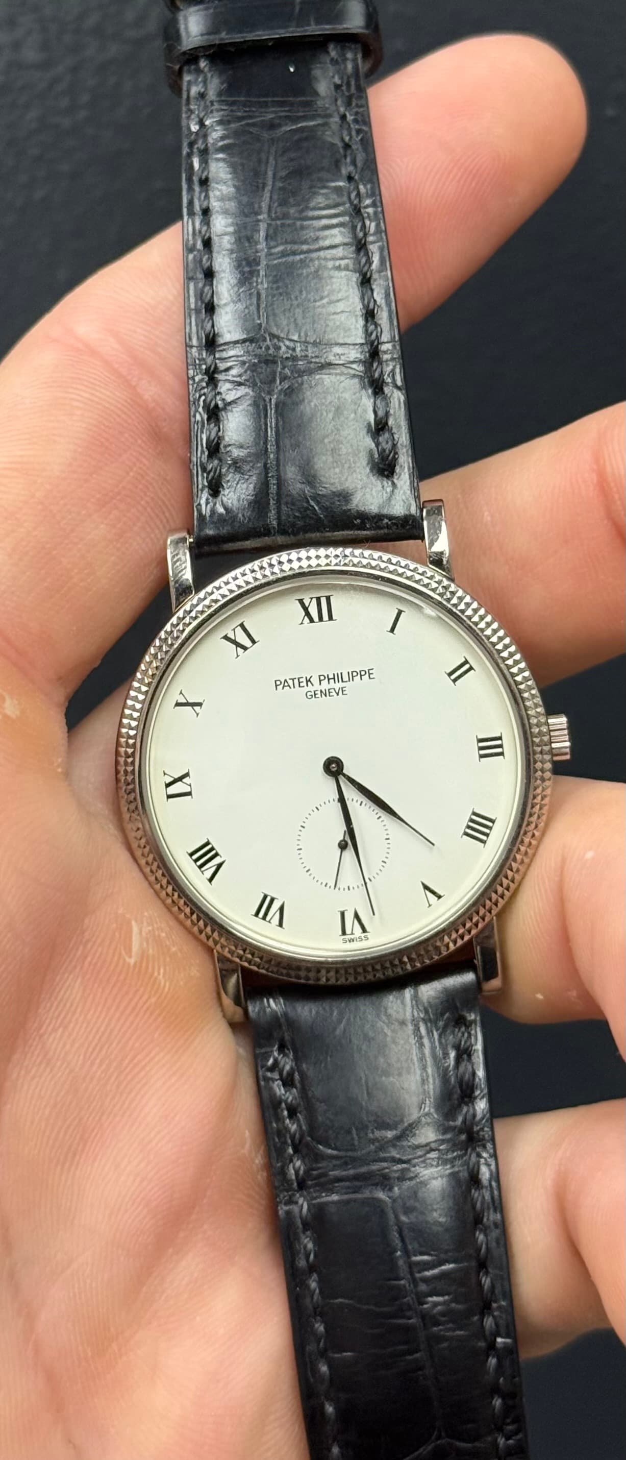 May be an image of wrist watch, leather and text that says '2 XII I XI PATEKPHILIPPE PATEK HILIPPE X GENEVE n IX W ወ III VI u I IA B0A3'