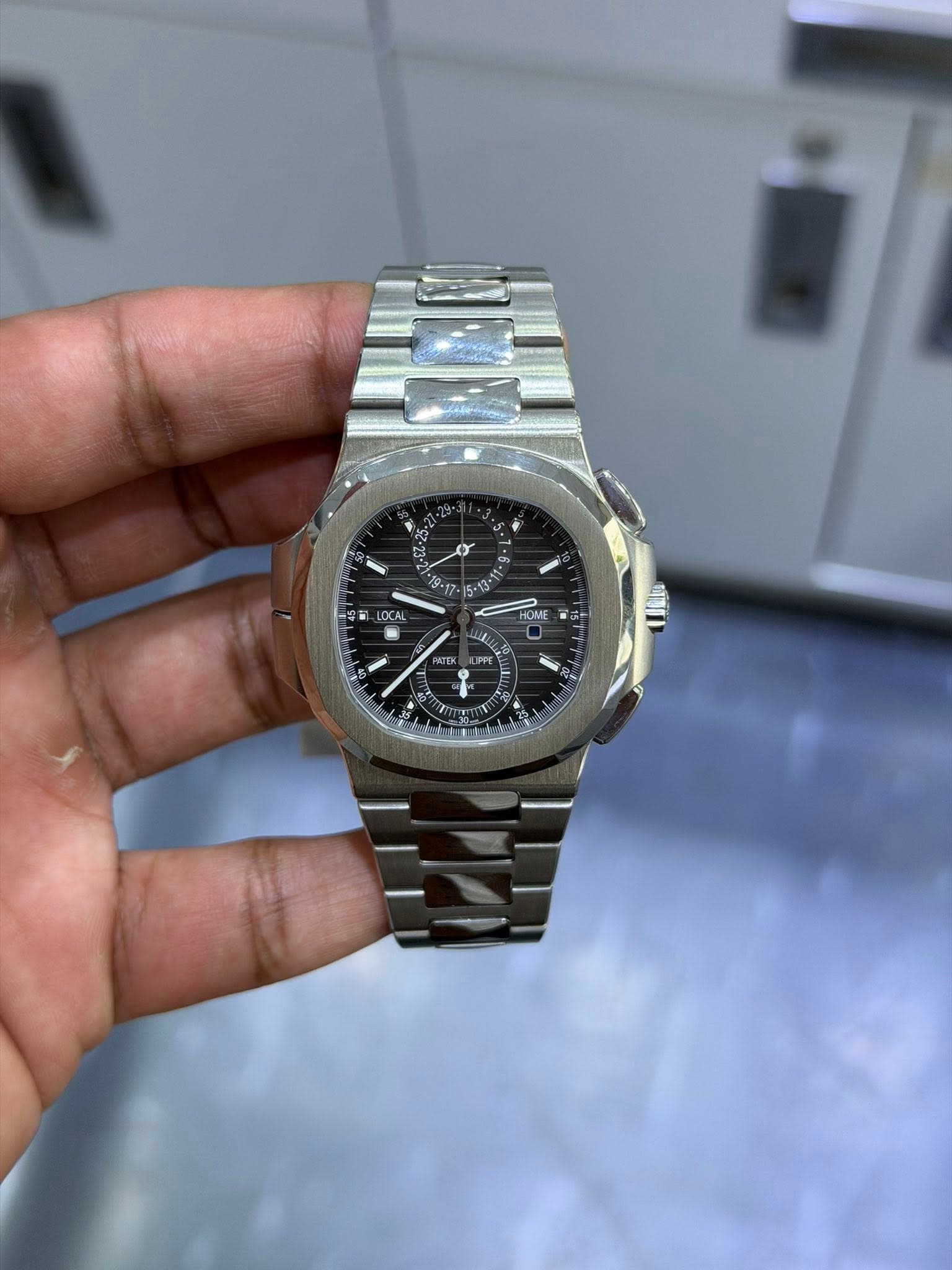 May be an image of wrist watch and text that says ' - LOCAL HOME OME ME NTEK L ل'