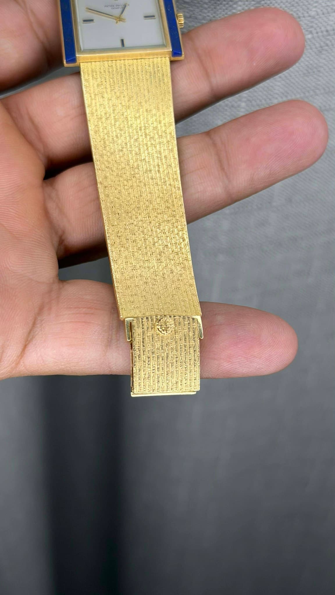 May be an image of wrist watch and text