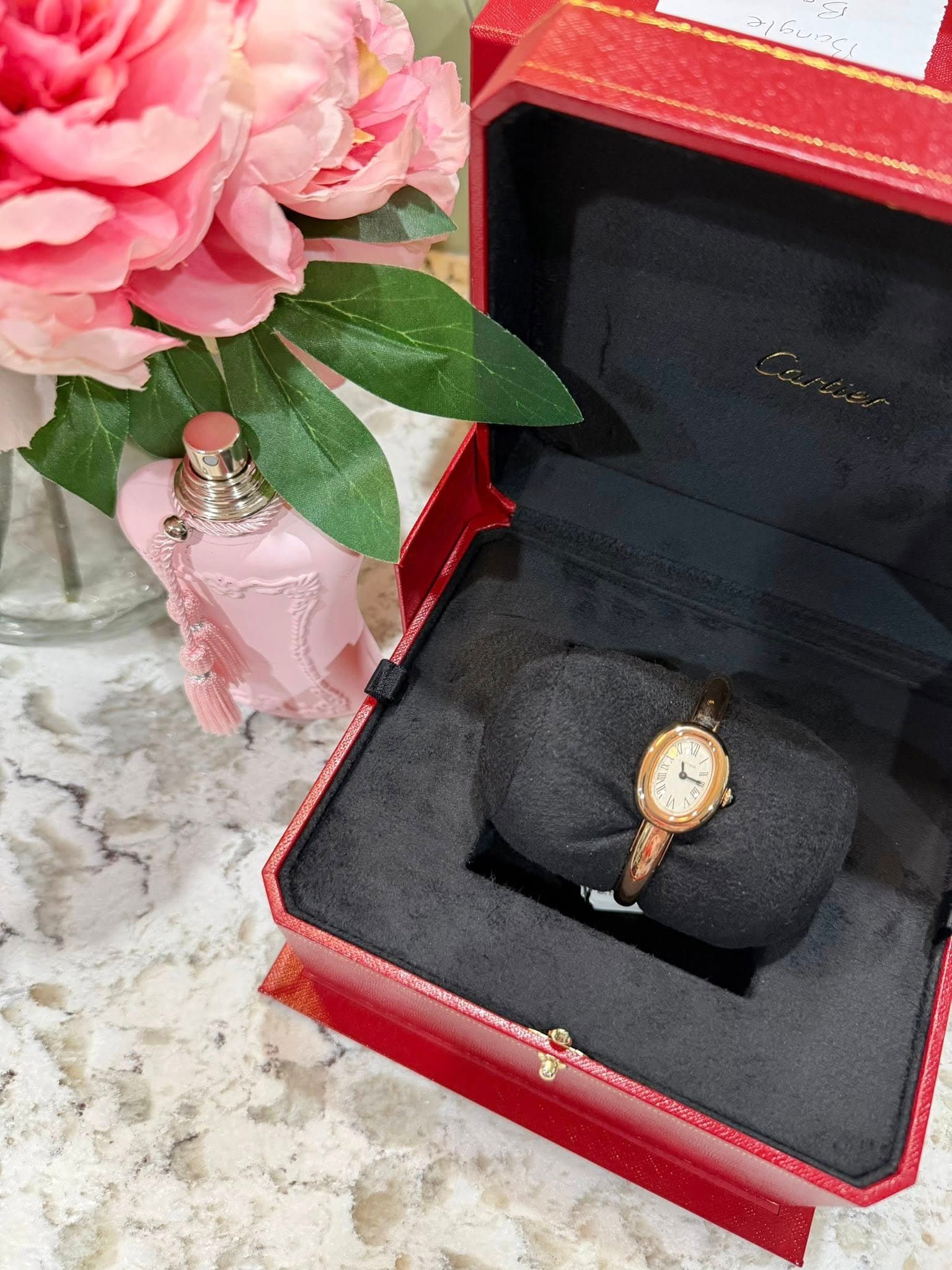 May be an image of wrist watch, ring and text