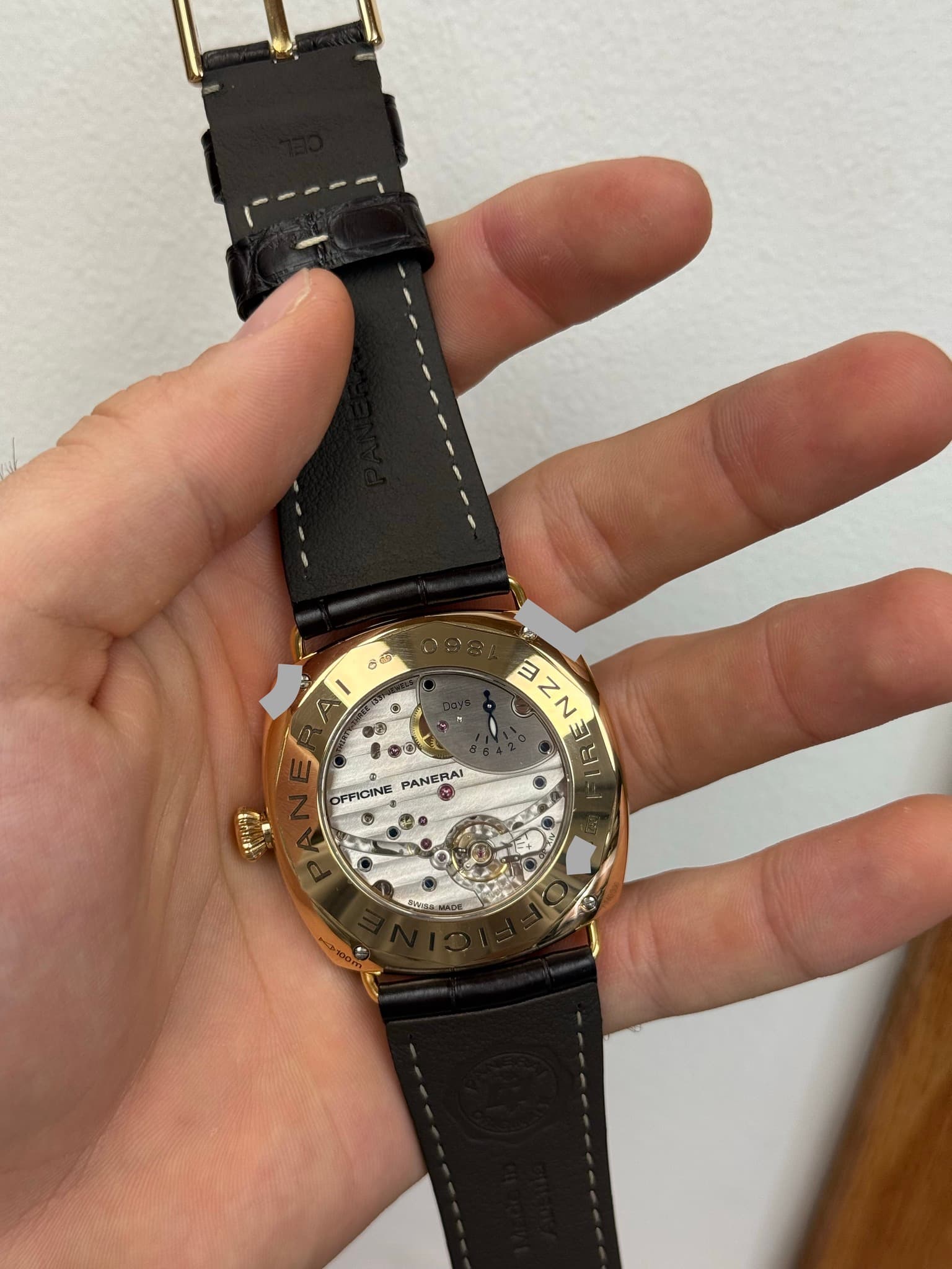 May be an image of wrist watch and text that says 'E U TINEH a OFFICINE PANERAI ل'