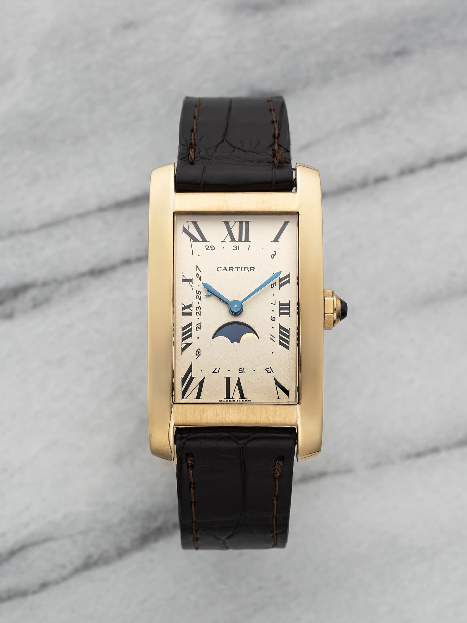 May be an image of wrist watch and text that says 'XII/ I X 29 XII I 31 ل د CARTIFR 5 0 II III E 25 XI ع 30. IIA A2 91 A L1 SI SHCTC I ا'