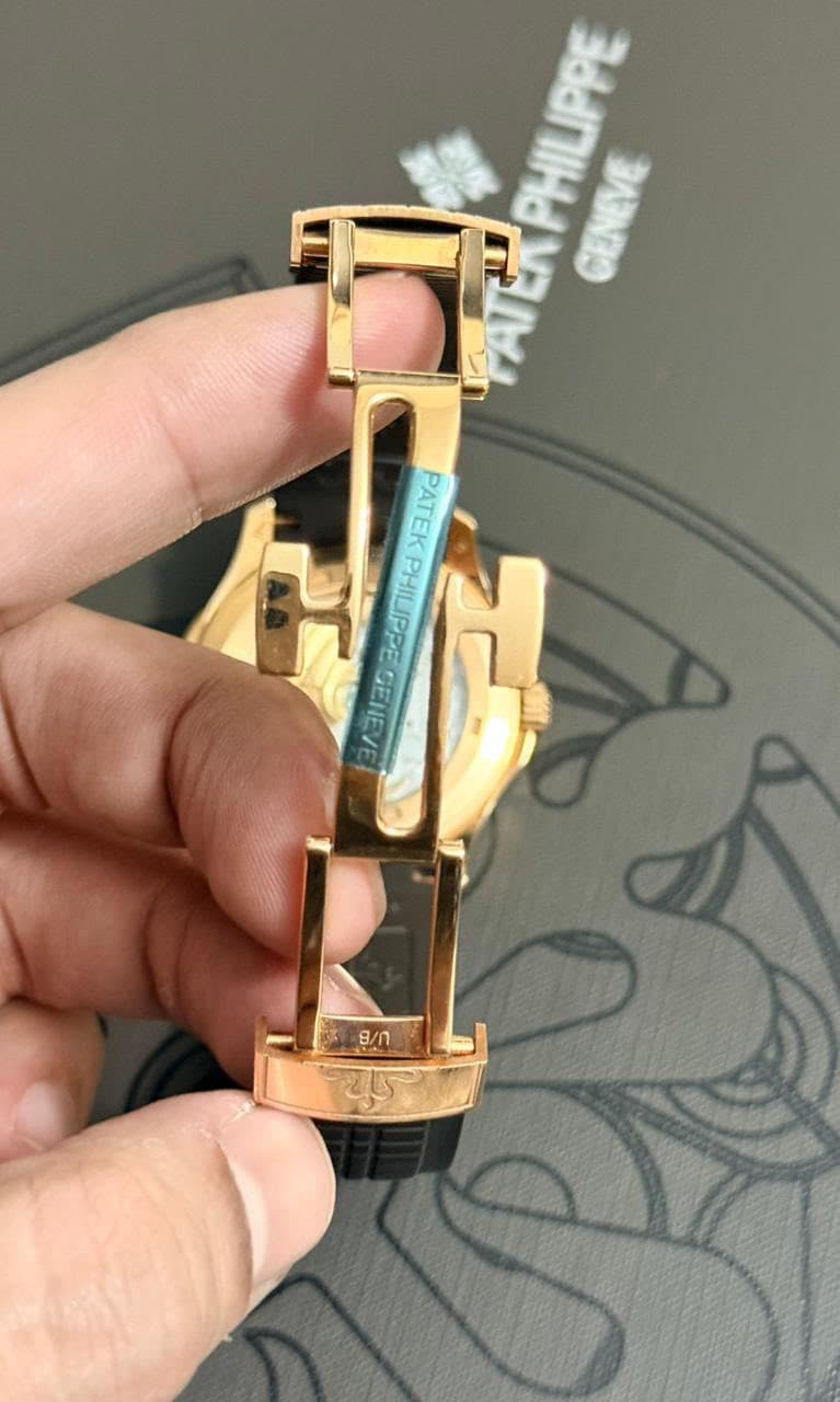 May be an image of wrist watch, brass and text