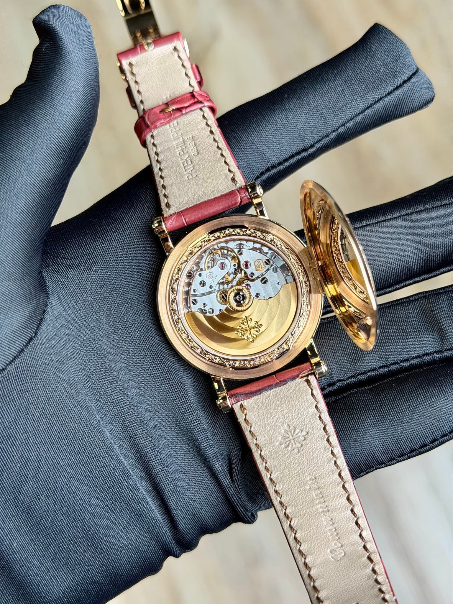 May be an image of wrist watch, leather and text