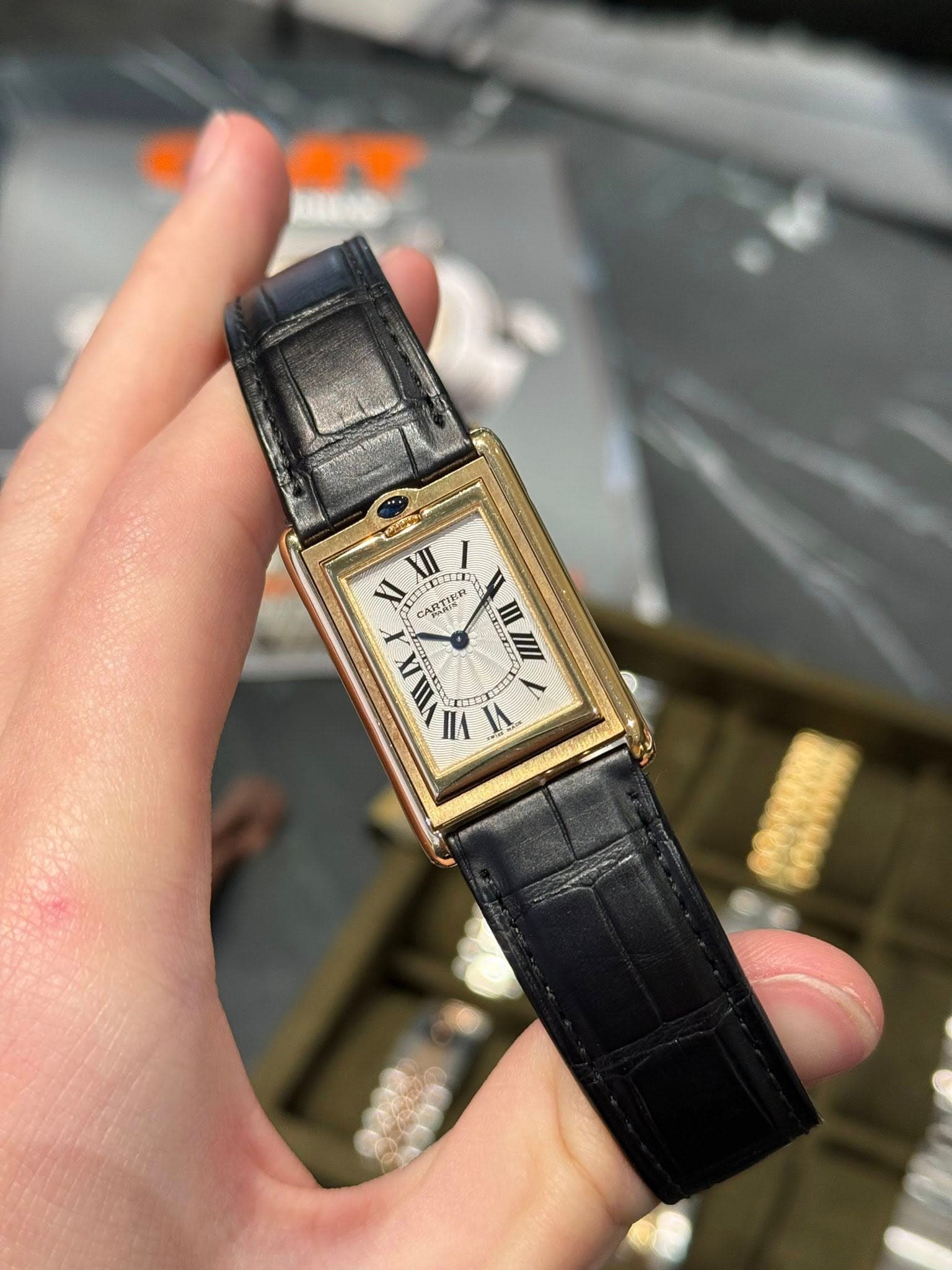 May be an image of wrist watch and text that says 'XI XIII m CARTI CARTIER III IX A T VII VI 0'