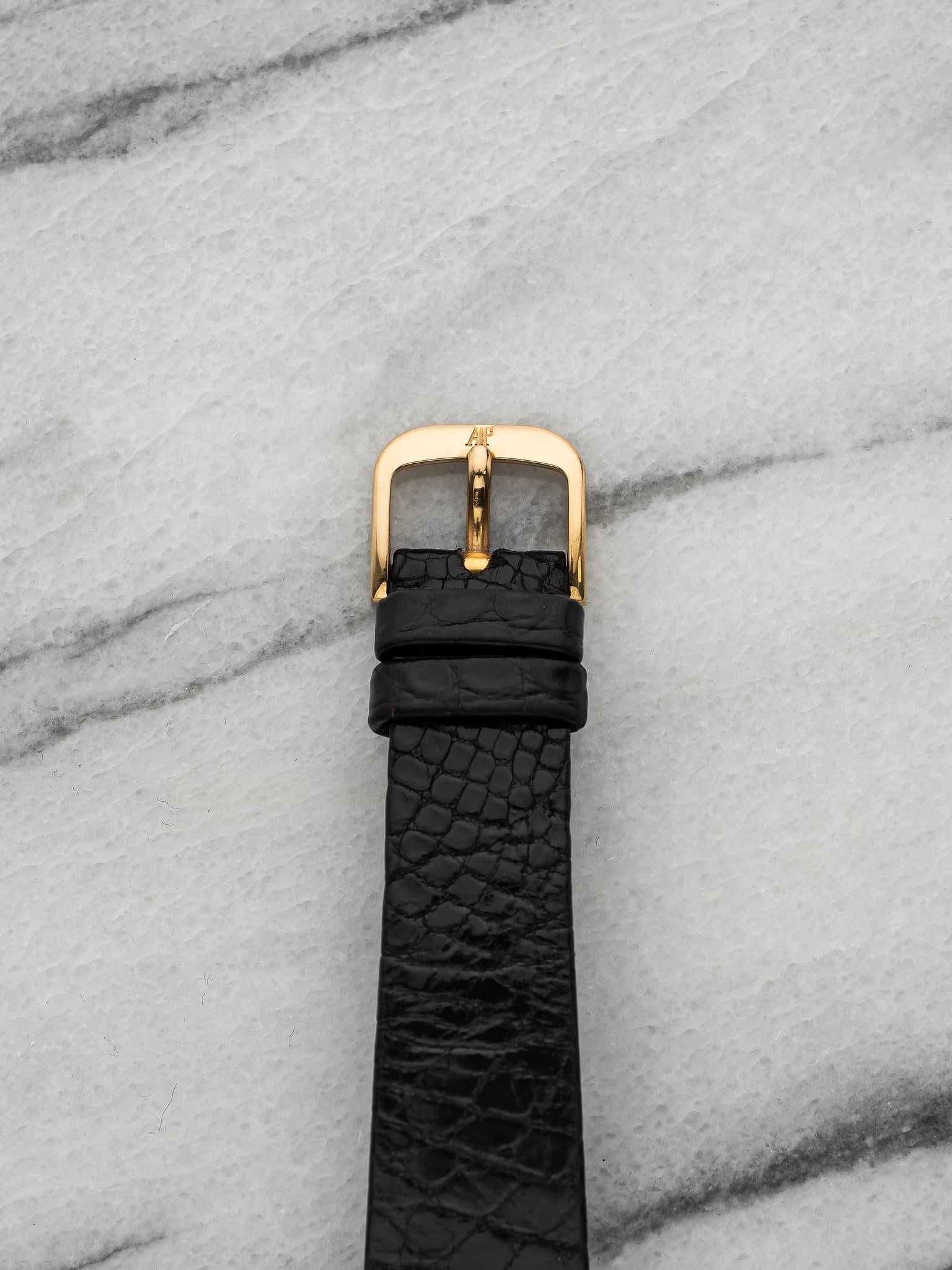 May be an image of saddle-stitched leather, leather and wrist watch