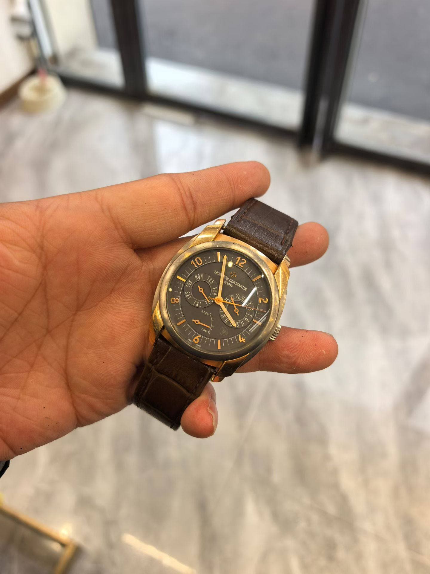 May be an image of wrist watch and text