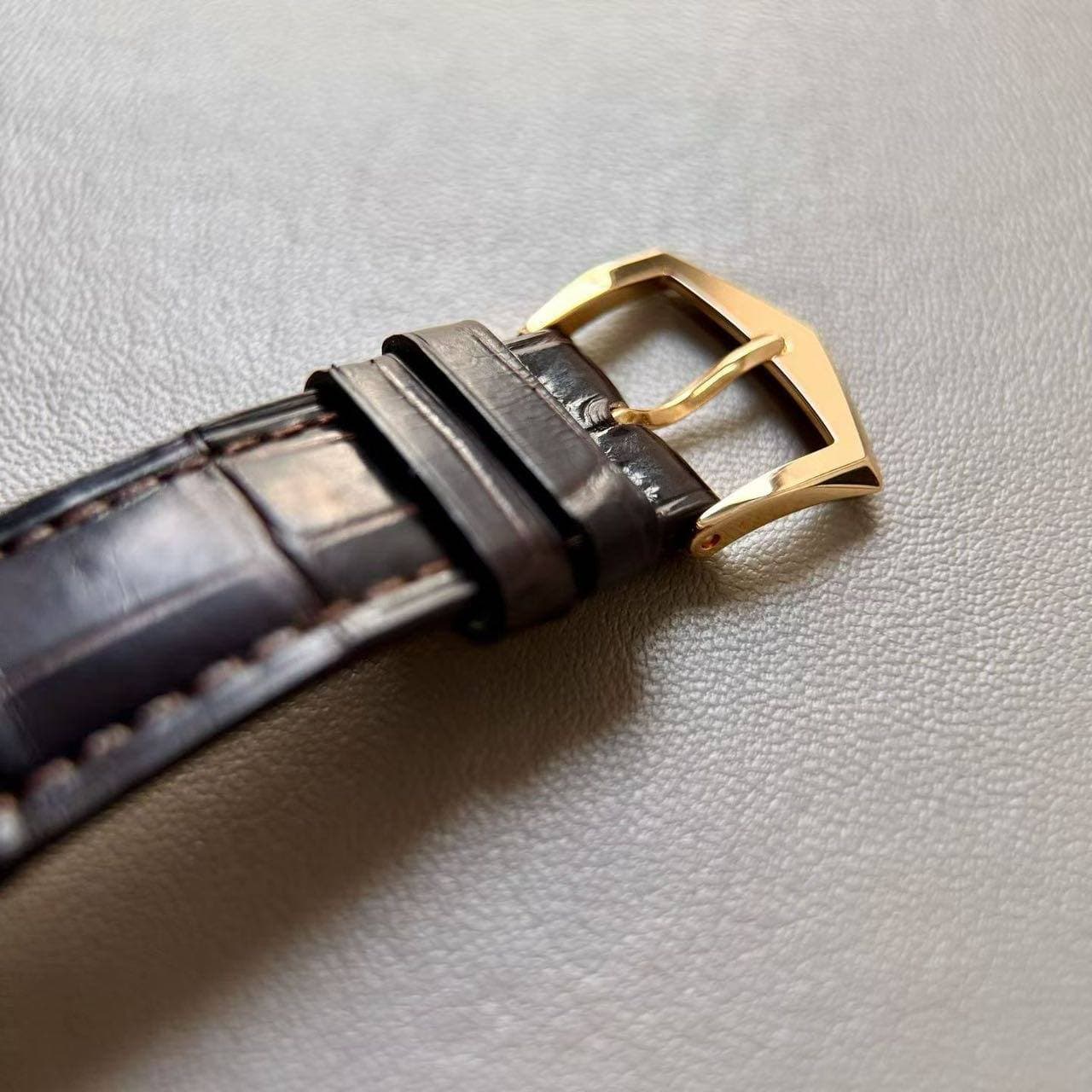 May be an image of leather, wrist watch and saddle-stitched leather