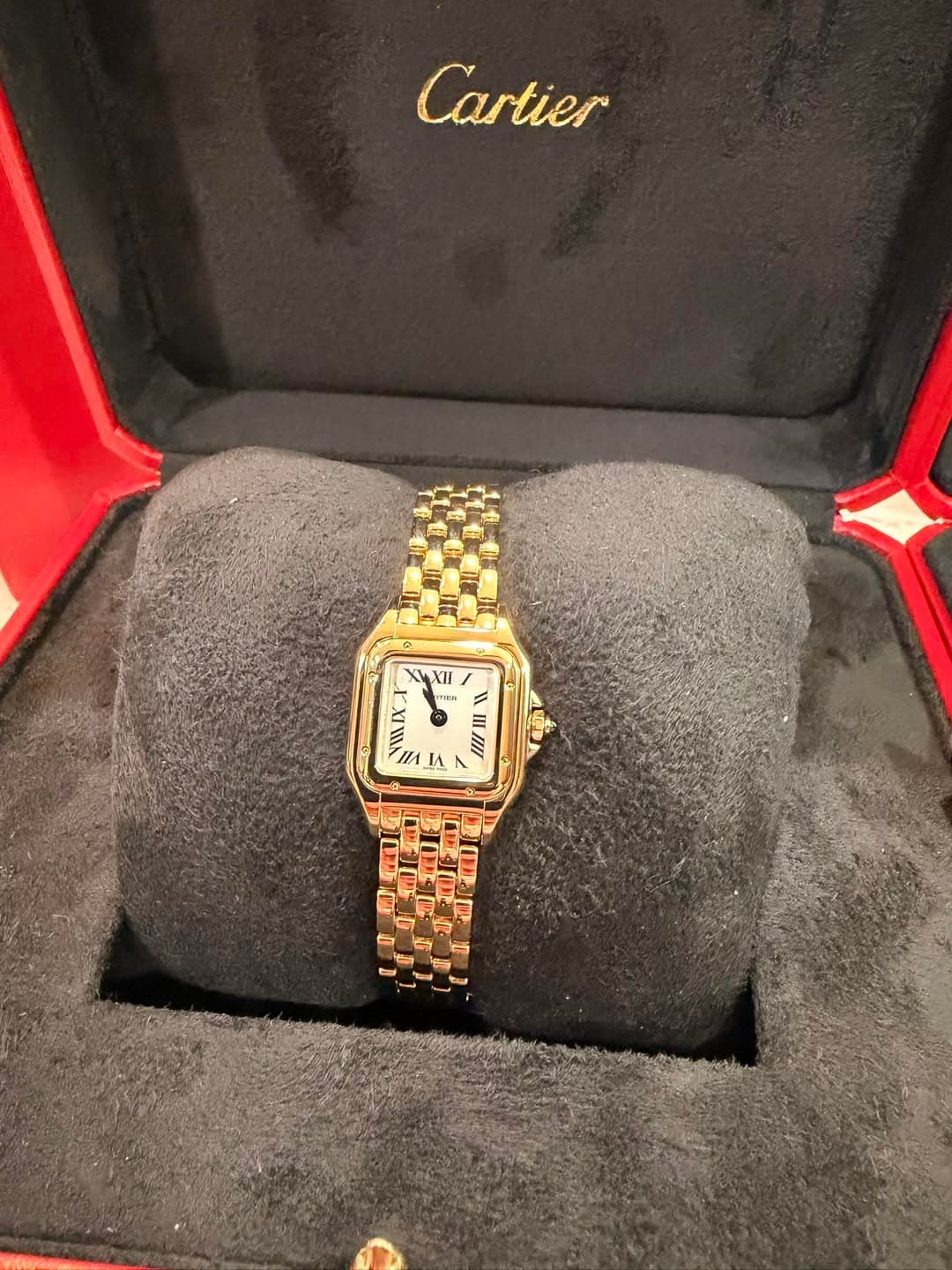 May be an image of wrist watch and text that says 'Cartier XII Tan 158 1 = I n IA A L TN FE'