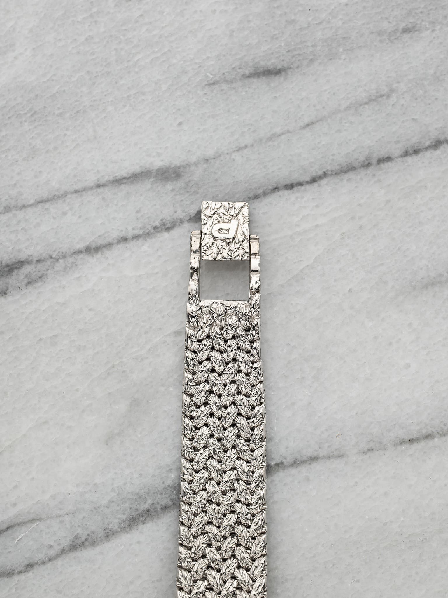 May be an image of wrist watch and jewelry