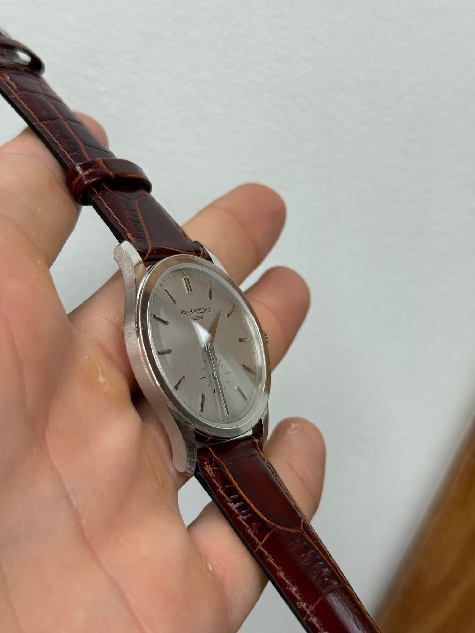 May be an image of wrist watch and saddle-stitched leather