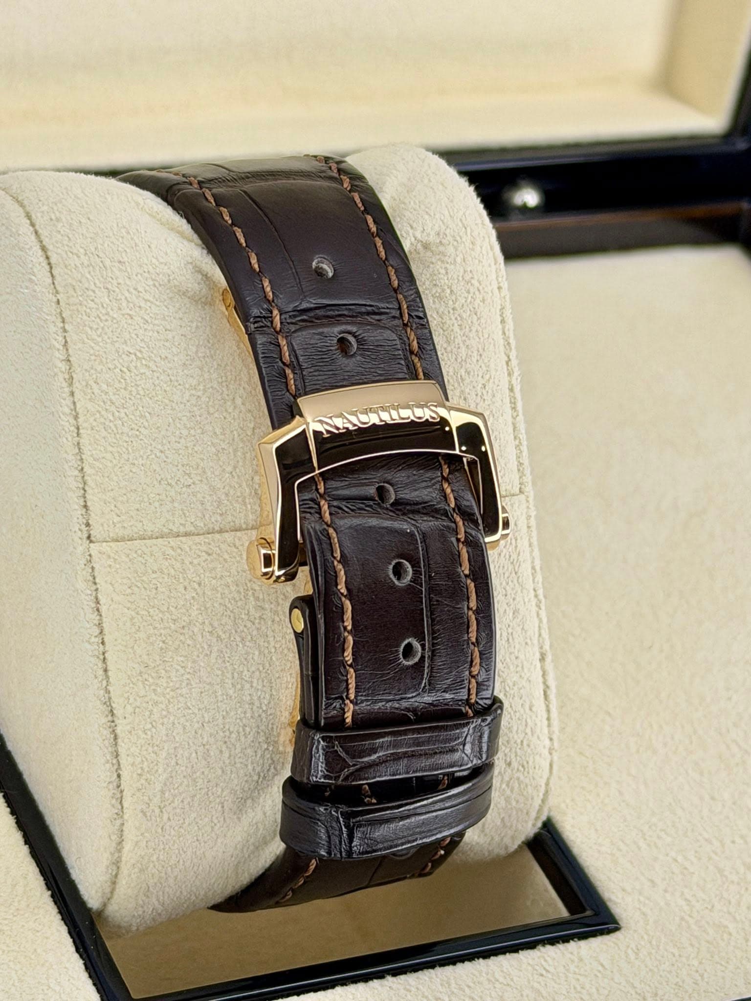 May be an image of leather, wrist watch and text