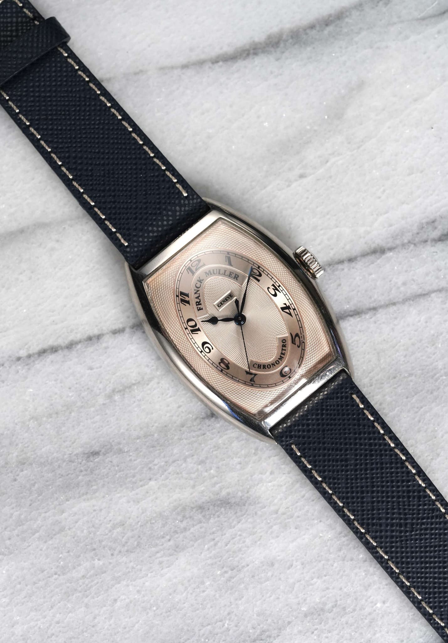 May be an image of wrist watch, leather and text