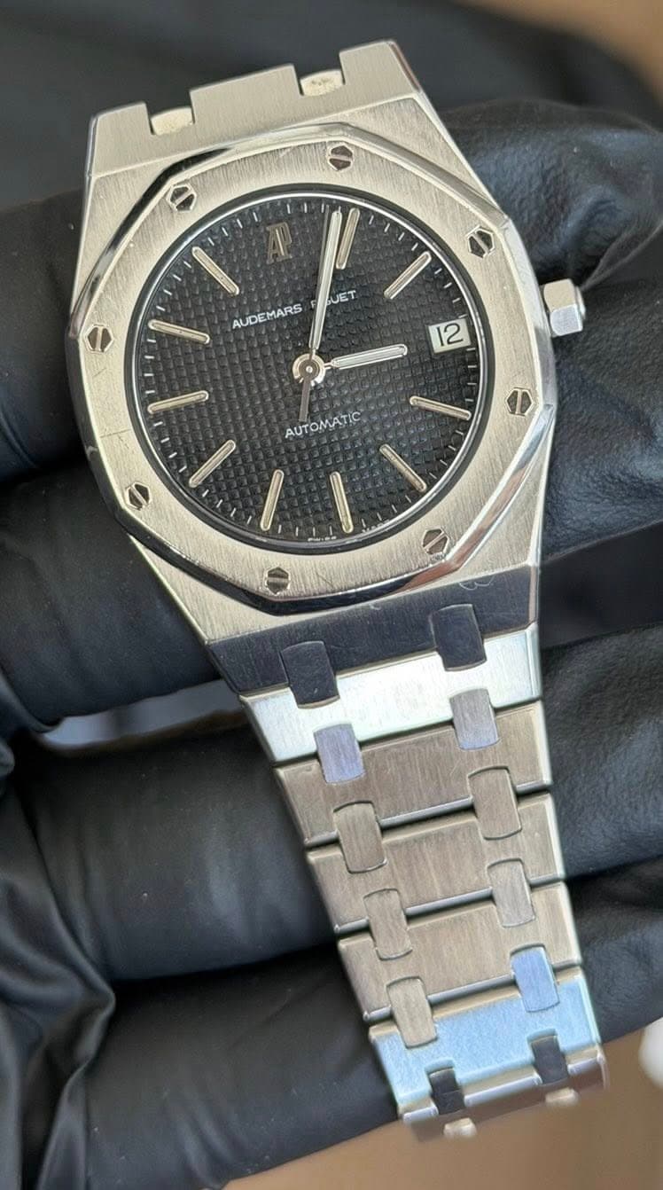 May be an image of wrist watch and text that says '9 AL JET AUDEMARS 2 9 OMC: AUTOMATIC I e'