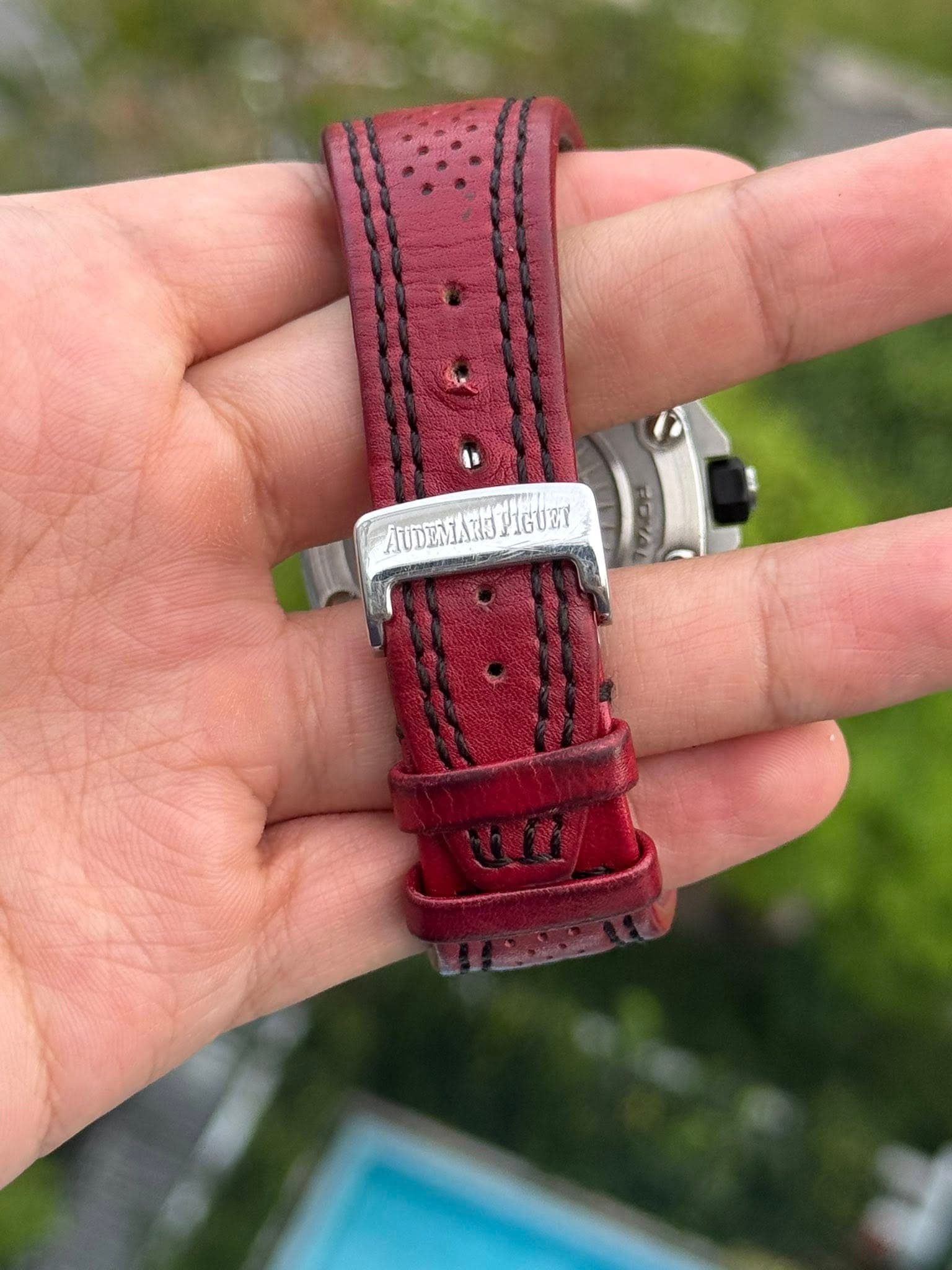 May be an image of saddle-stitched leather, wrist watch and text that says 'PIGUEY'