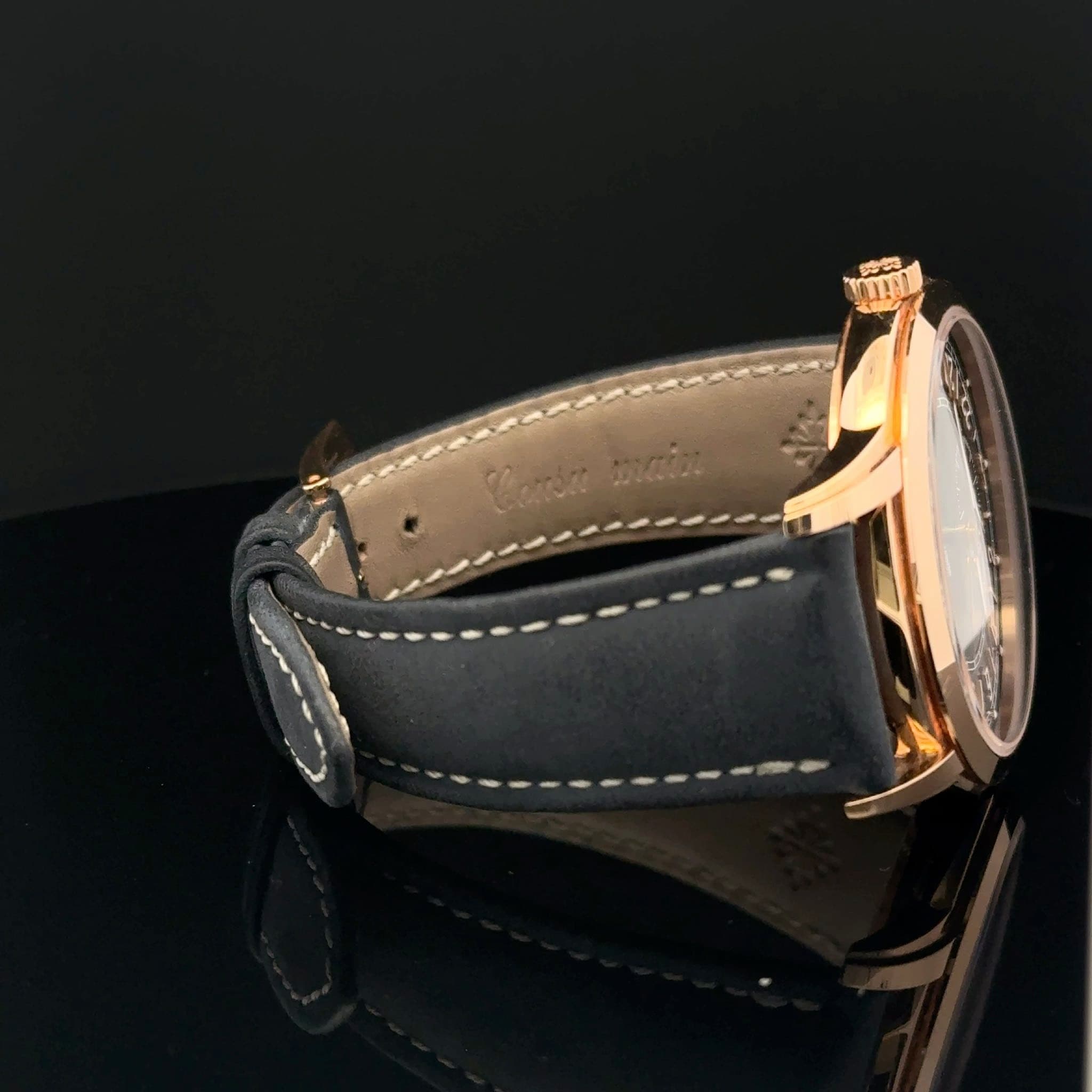May be an image of saddle-stitched leather and wrist watch