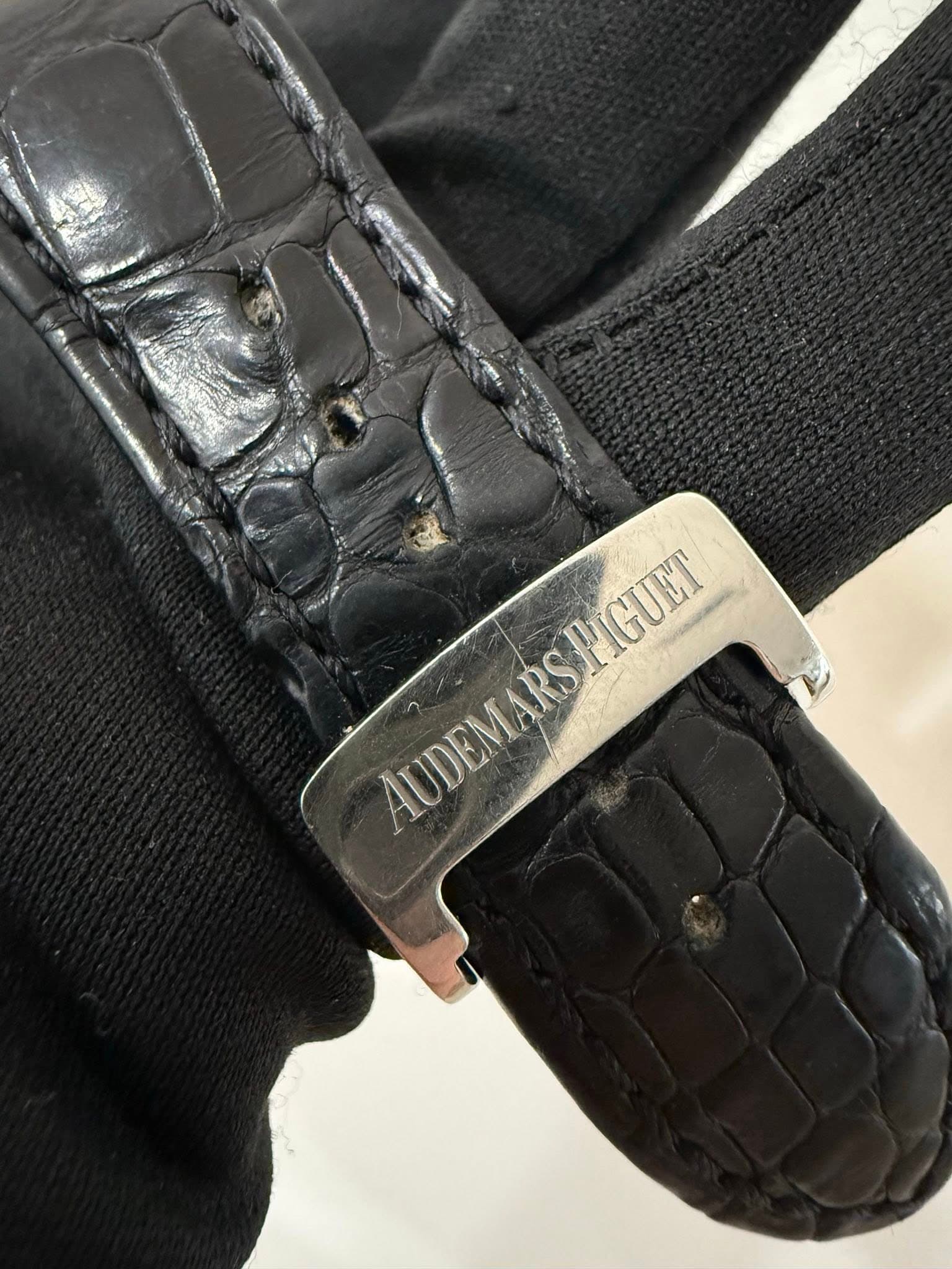 May be an image of wrist watch, leather and text