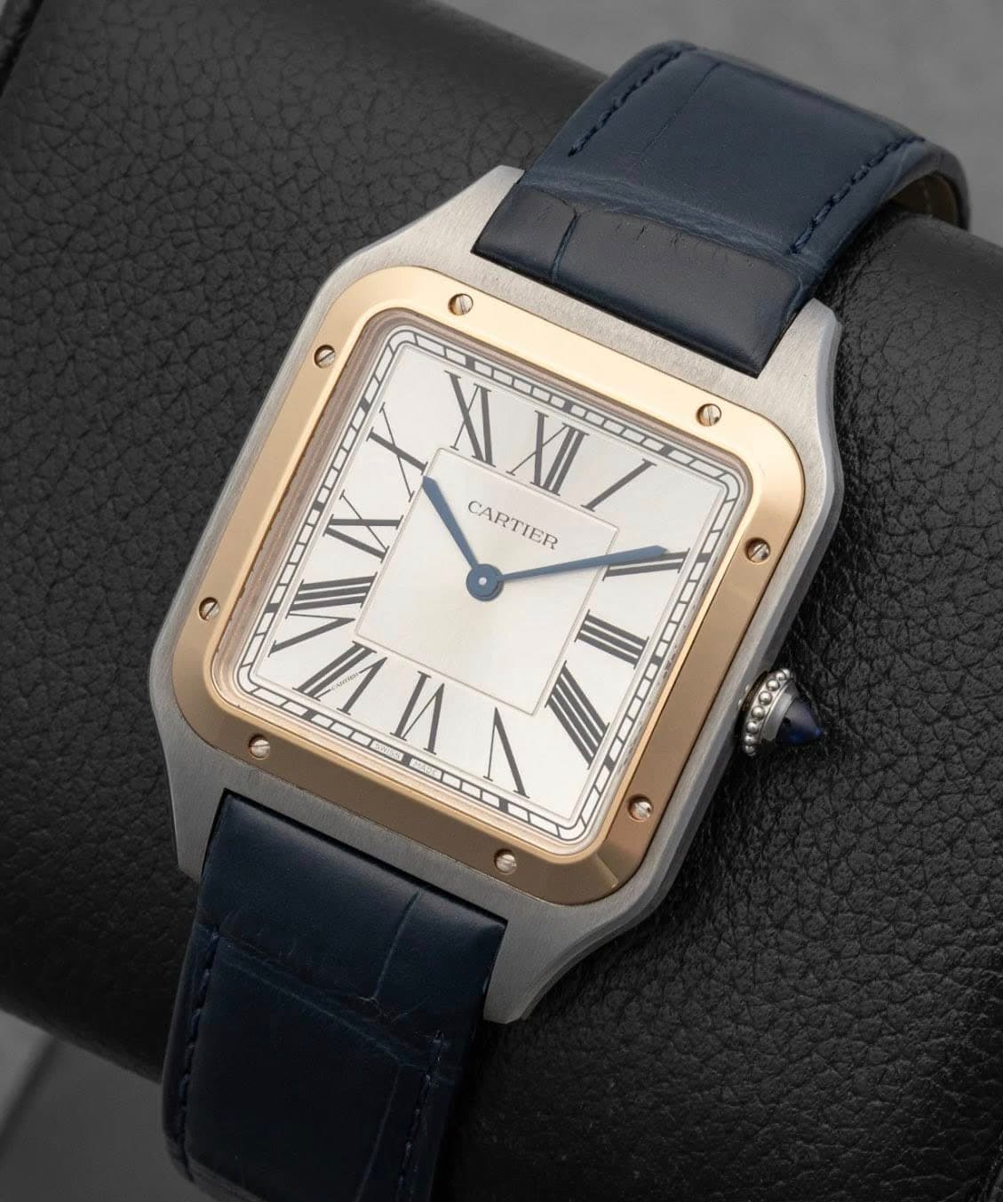May be an image of wrist watch and text that says 'ဝ ٥ XI WXII XII IX CARTIER HI VI I C 99'