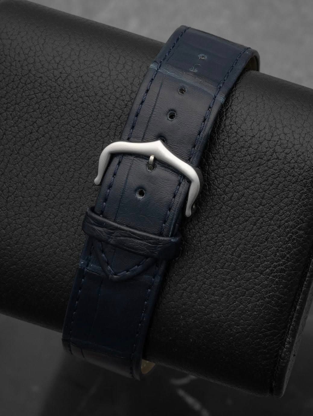 May be an image of saddle-stitched leather, leather and wrist watch