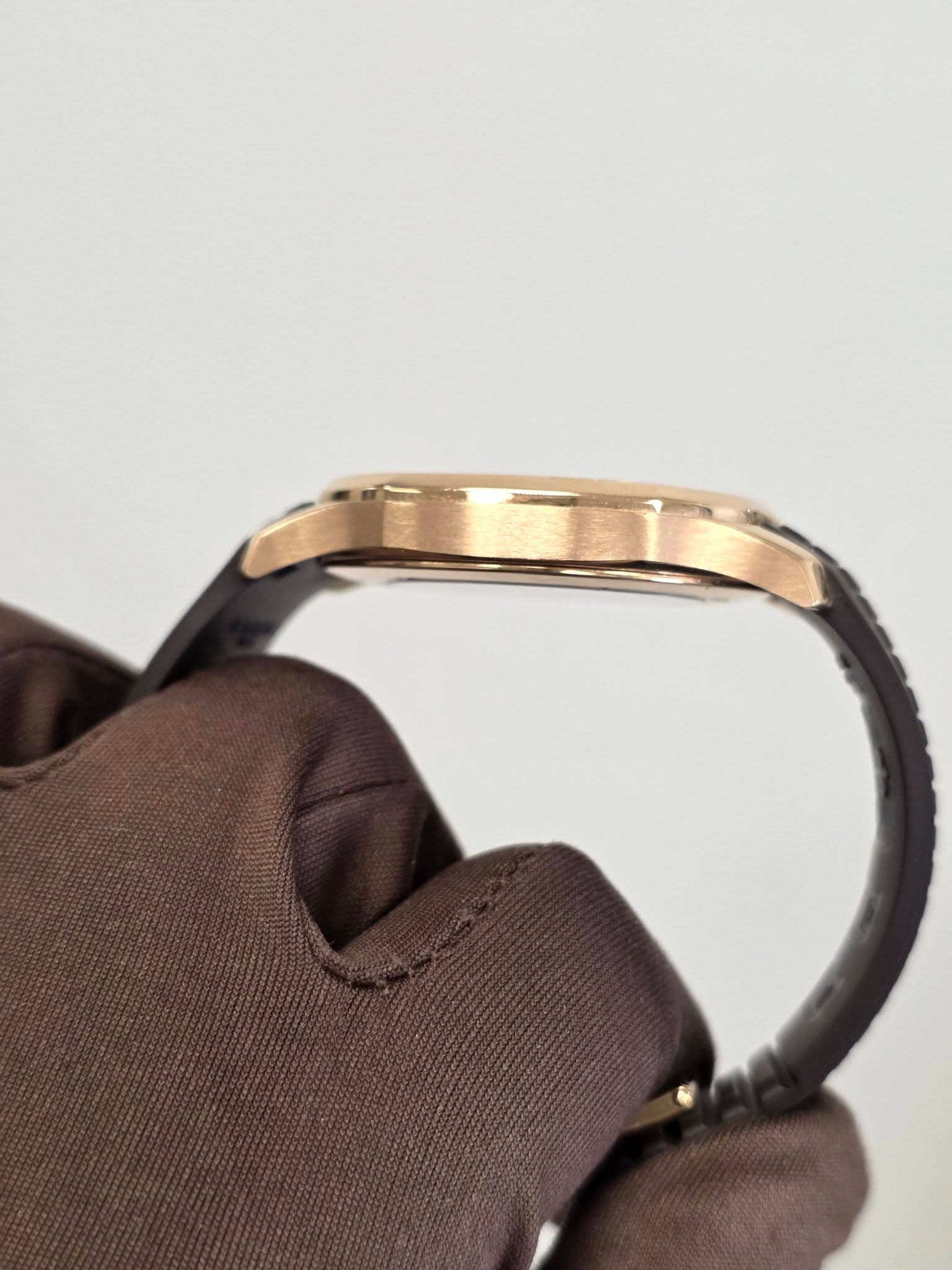 May be an image of wrist watch, leather, saddle-stitched leather and brass