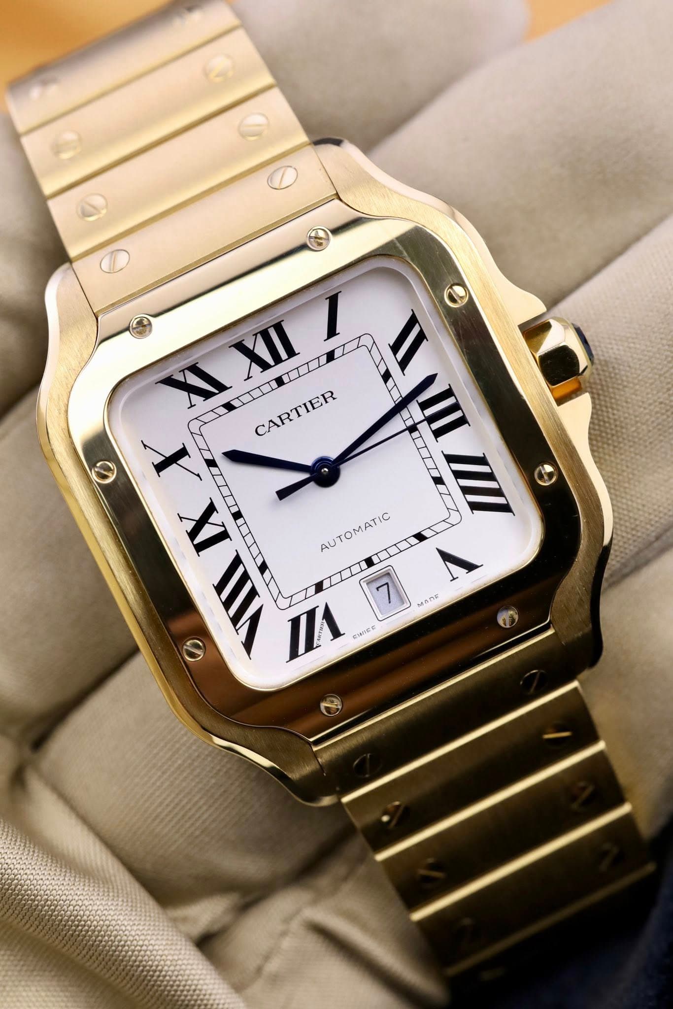 May be an image of wrist watch and text that says '6 XIII I 1 II XI CARTIER T III X IEI T IX AUTOMATIC 一部 口盒 7 MADE nл CIme ဖ ®'