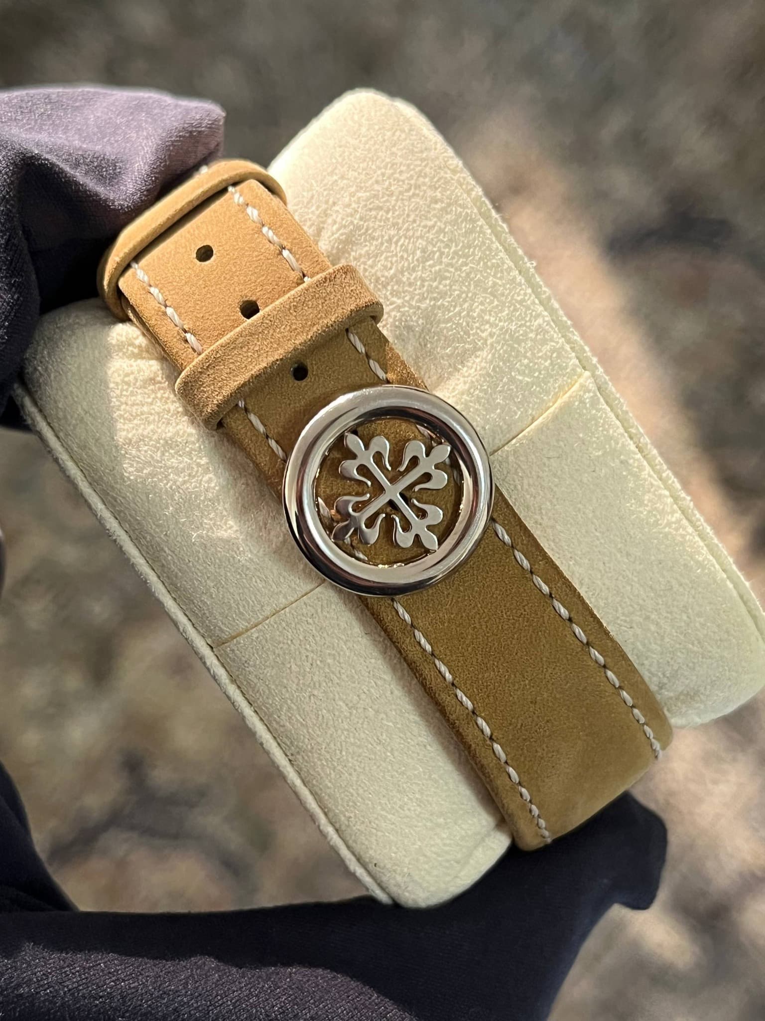 May be an image of leather, wrist watch and text