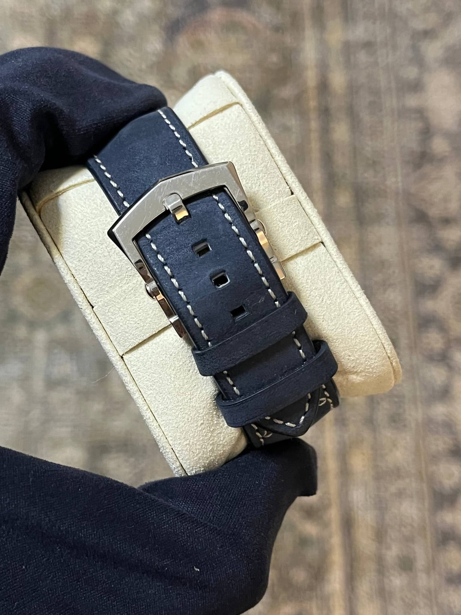 May be an image of leather, saddle-stitched leather and wrist watch