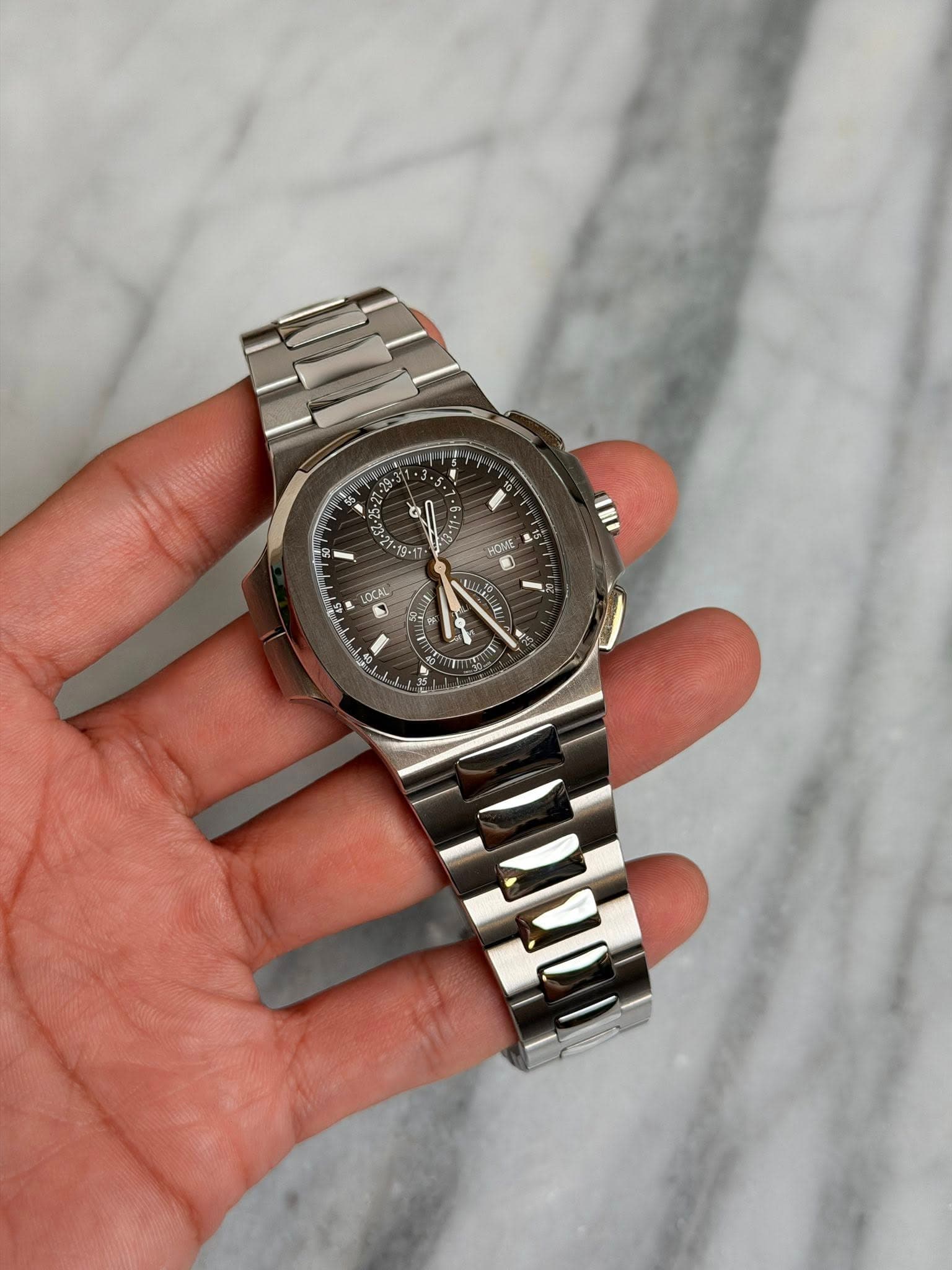 May be an image of wrist watch and text