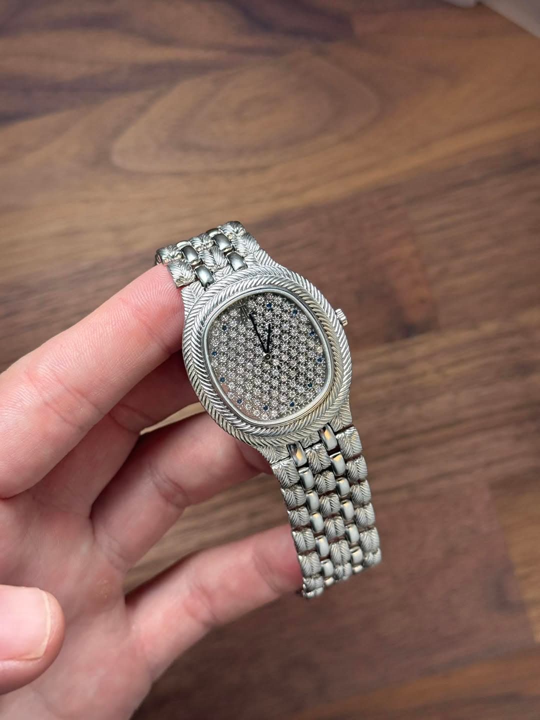 May be an image of wrist watch and text