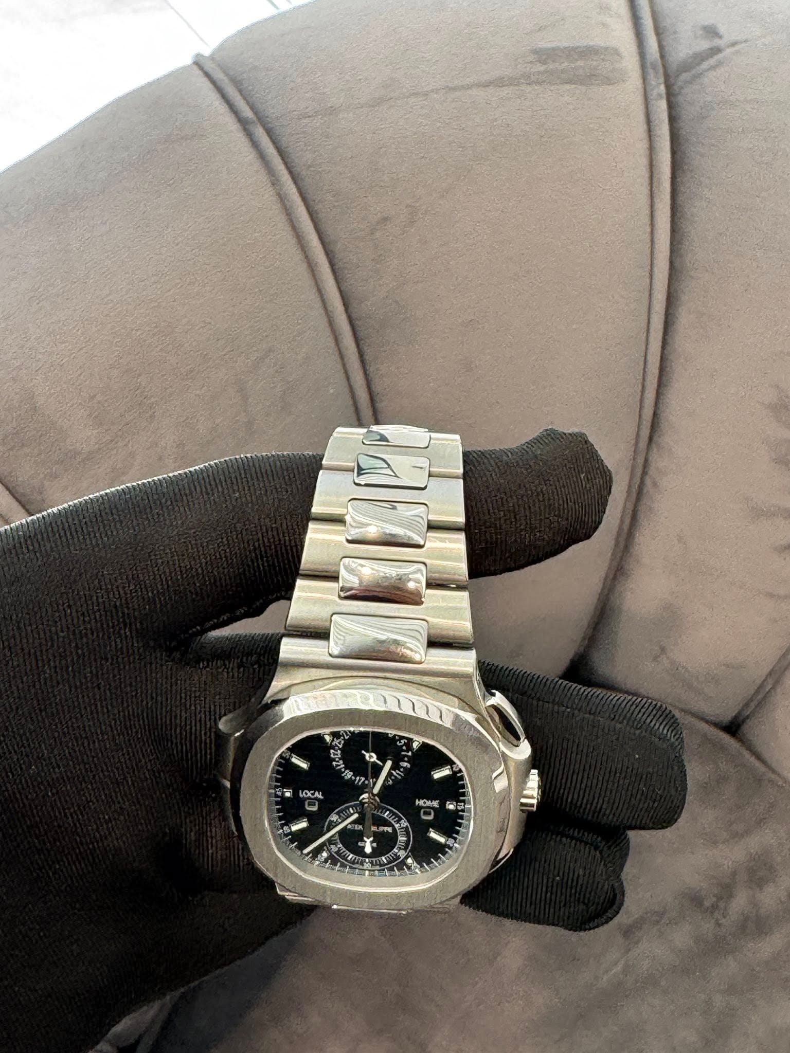 May be an image of wrist watch and text that says 'n ብ / W Y'