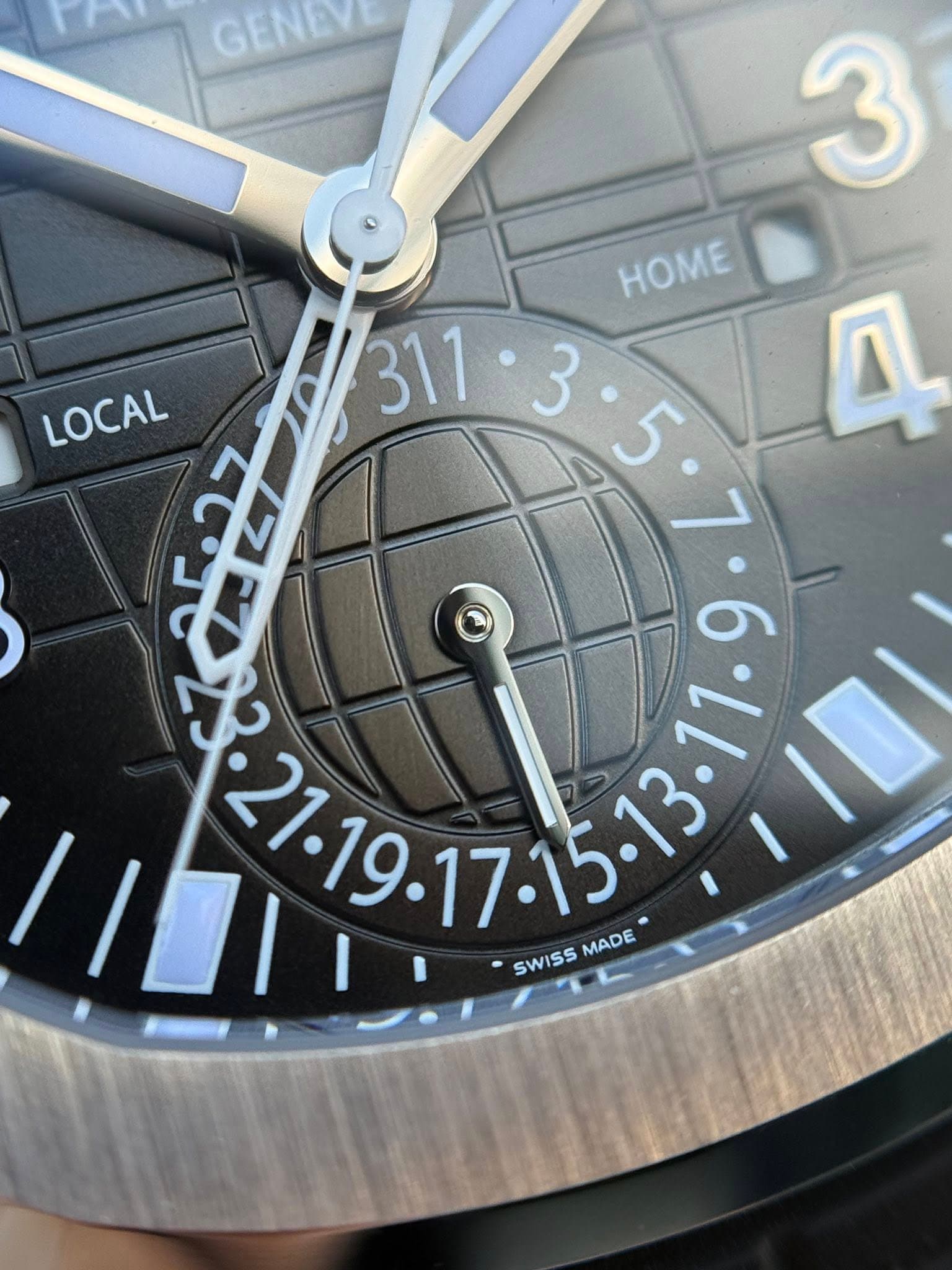 May be an image of wrist watch and text that says 'GENEVE 3 HOME LOCAL 110T 7053 SWISS MADE'