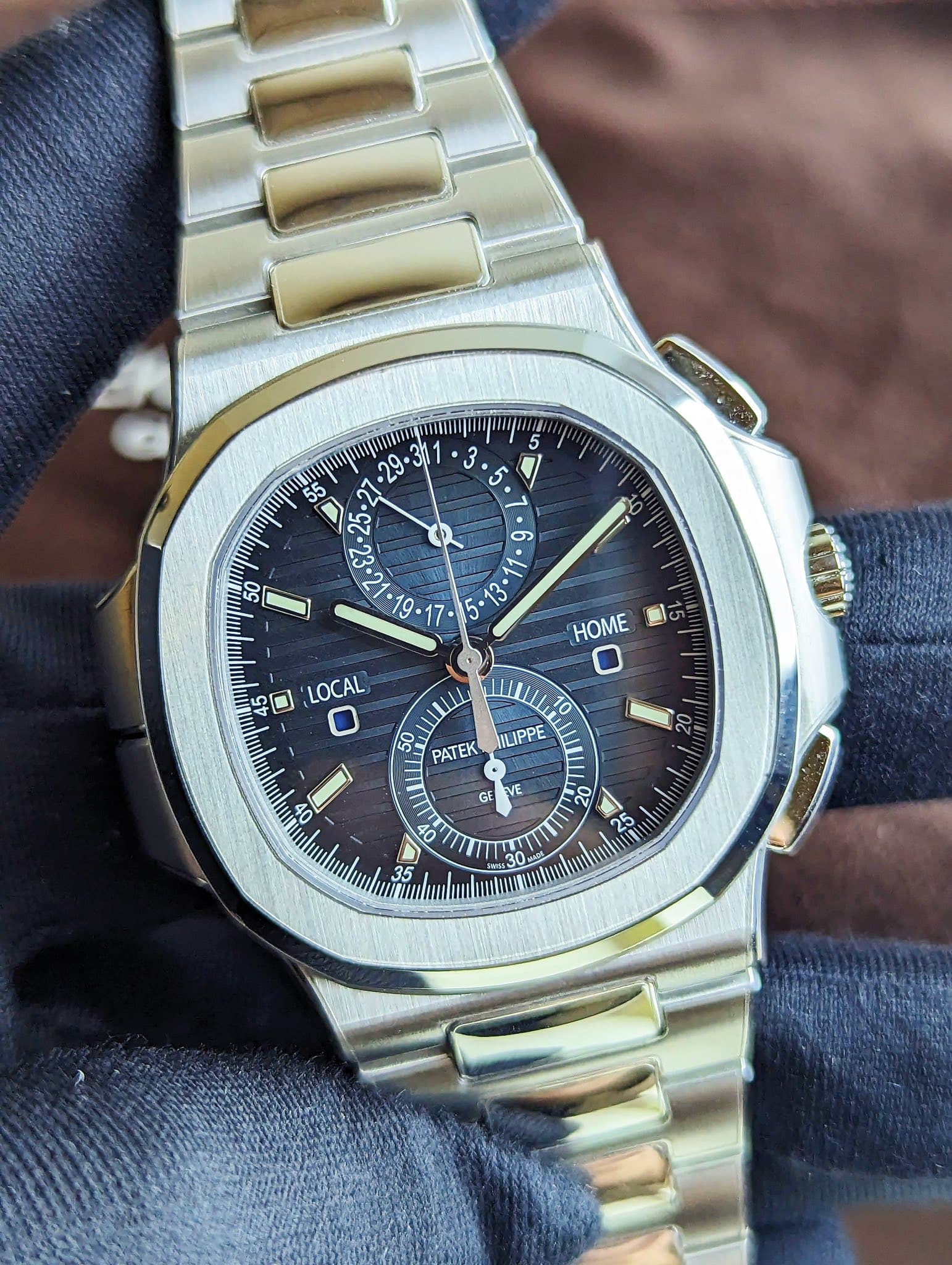 May be an image of wrist watch and text that says 'm וייין ° ර 50 5 HOME K5 nu 6 סס መመ 45 0 LOCAL 50 PATEK ULIPPE O0 GE VE '