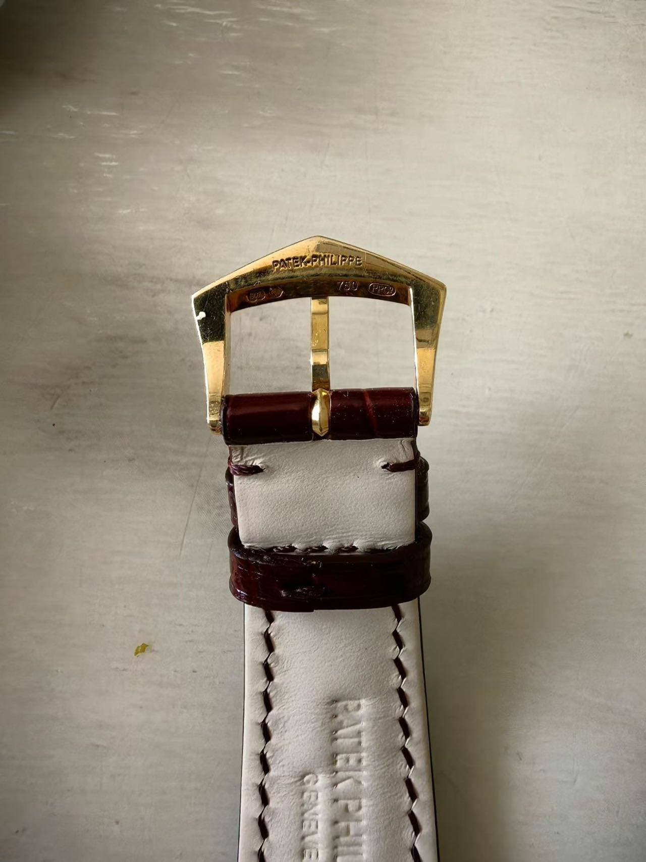 May be an image of wrist watch, saddle-stitched leather and text