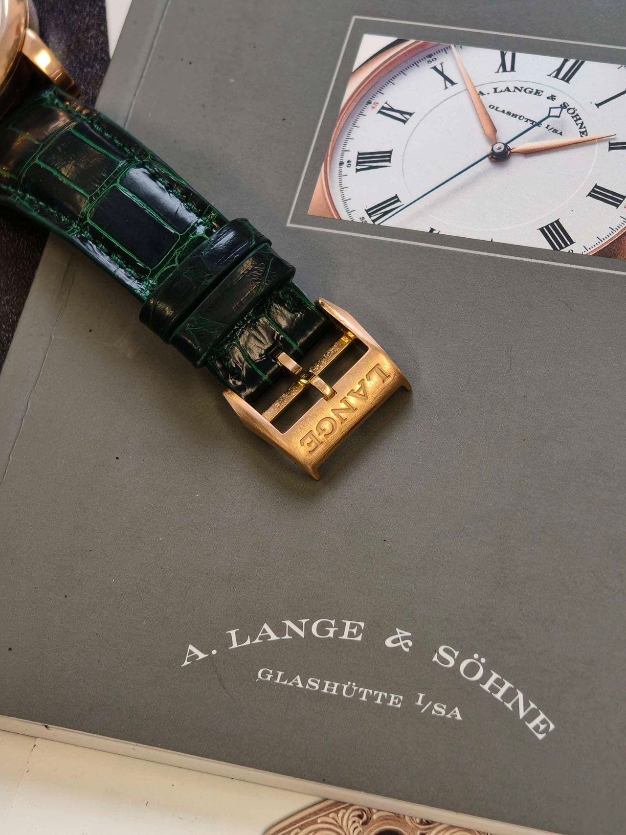 May be an image of wrist watch, saddle-stitched leather and text
