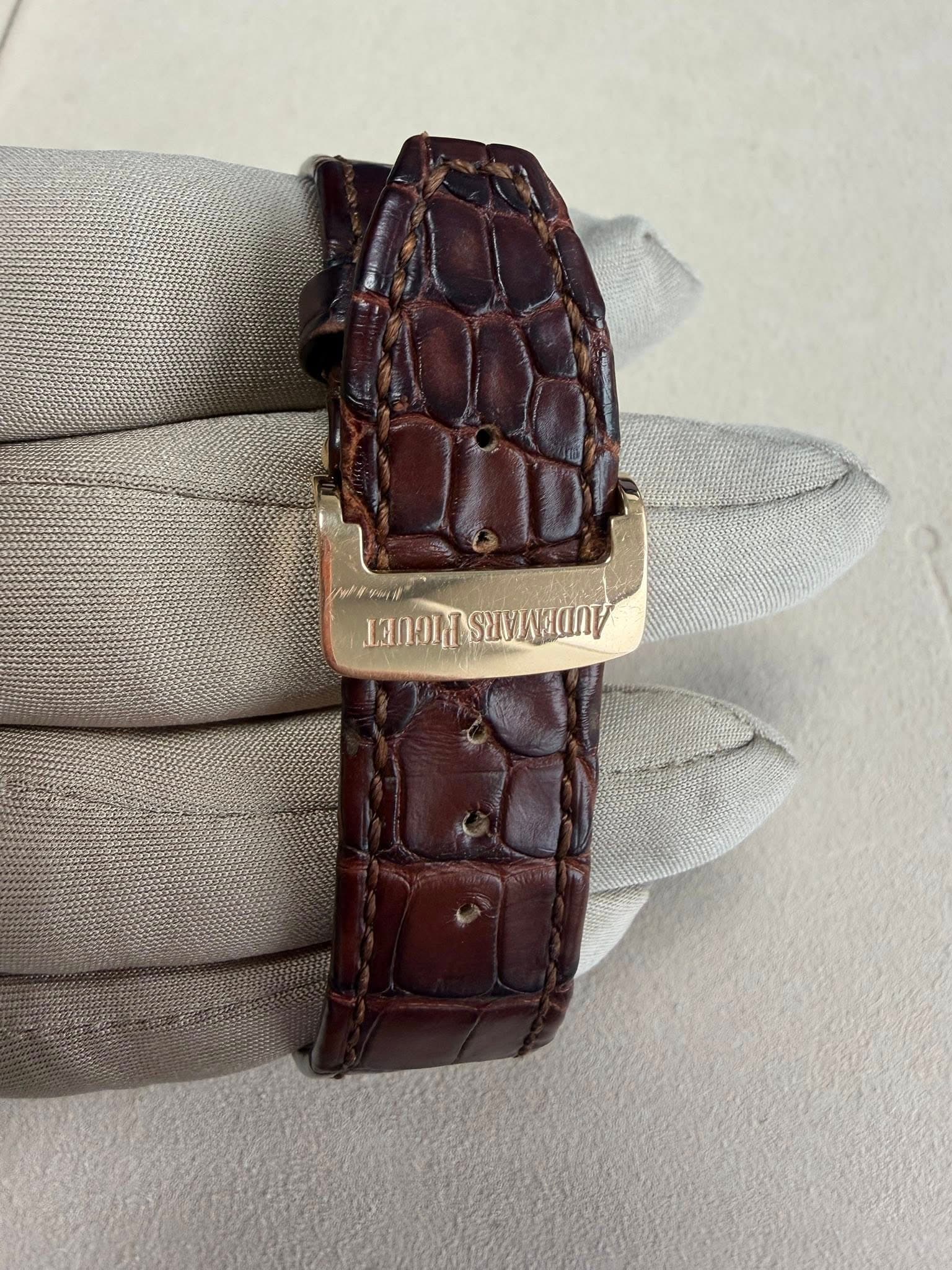 May be an image of leather, wrist watch and text