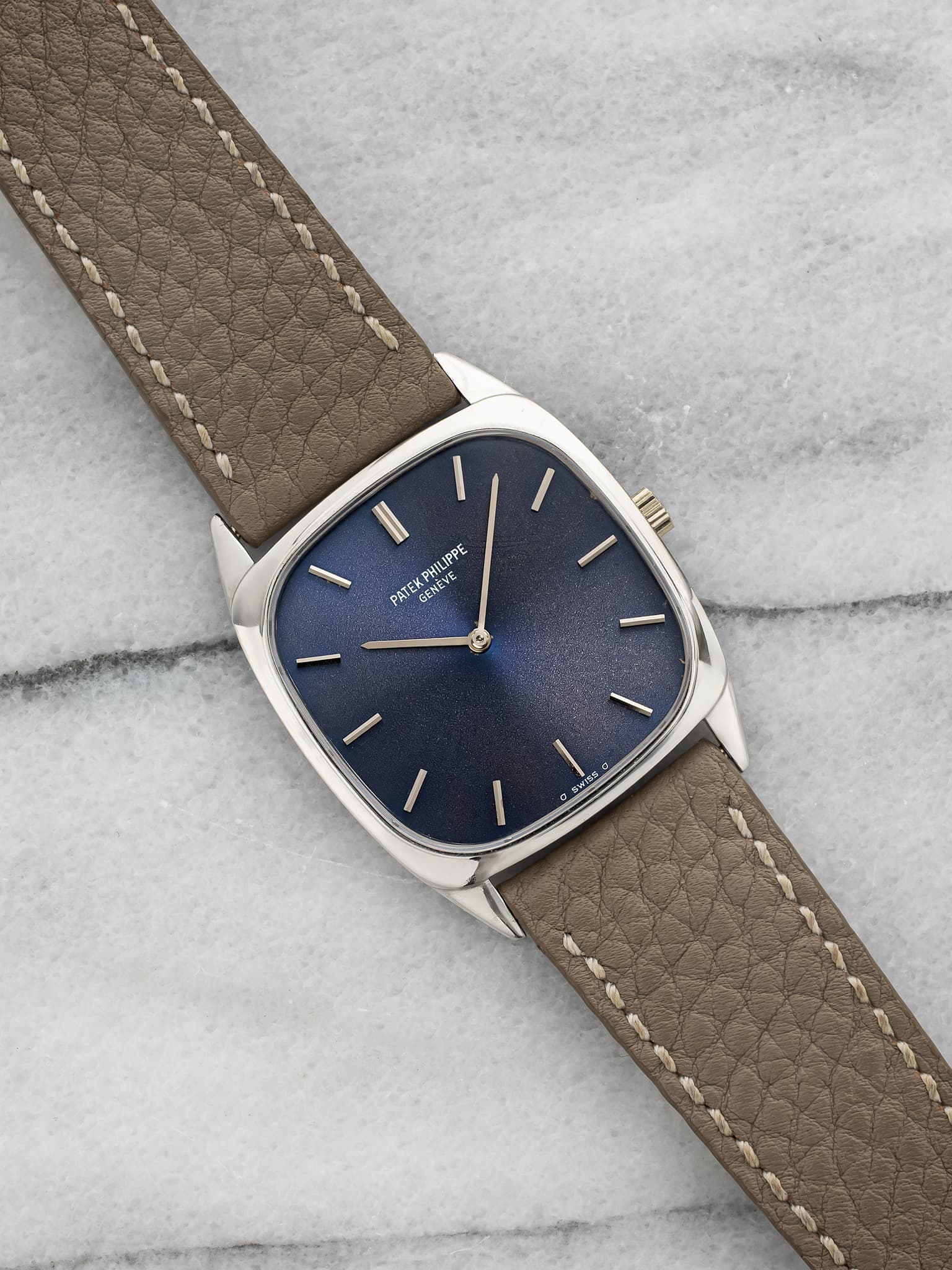 May be an image of leather, wrist watch and text
