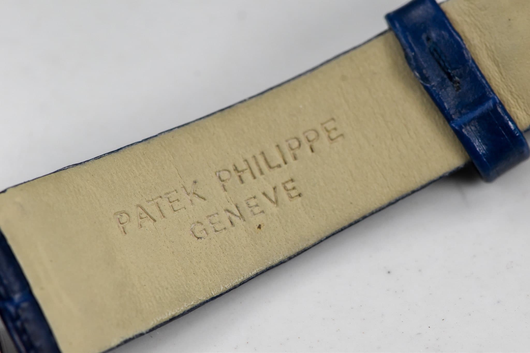 May be an image of leather, wrist watch and text that says 'PHILIPPE PHILIPPE PATEK GENEVE GENEVE'