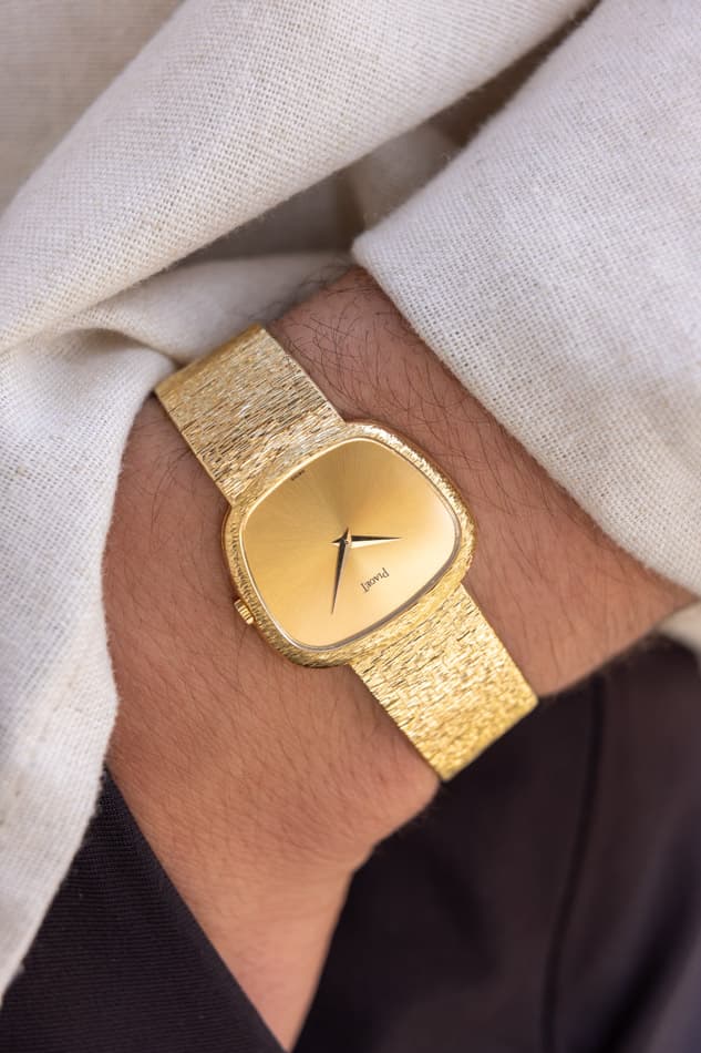 May be an image of wrist watch, jewelry and text