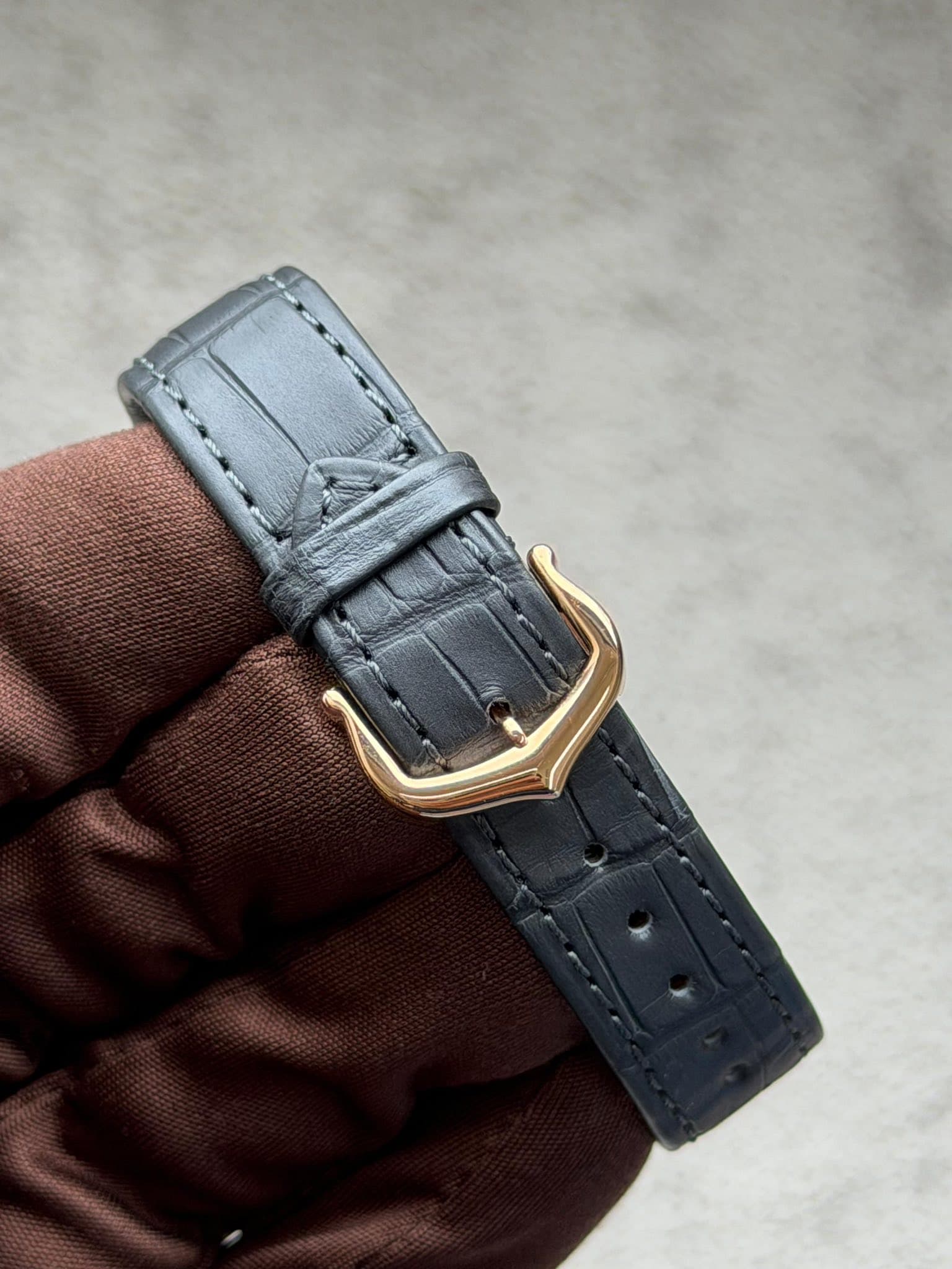 May be an image of leather, saddle-stitched leather, wrist watch and text