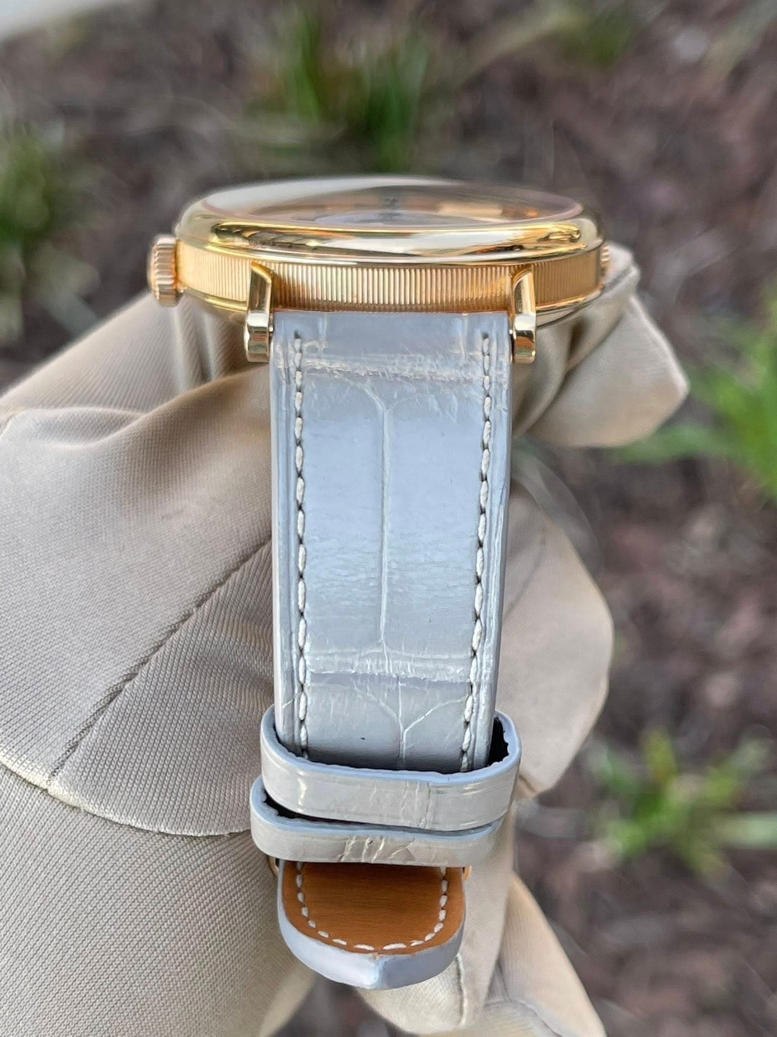 May be an image of wrist watch and saddle-stitched leather