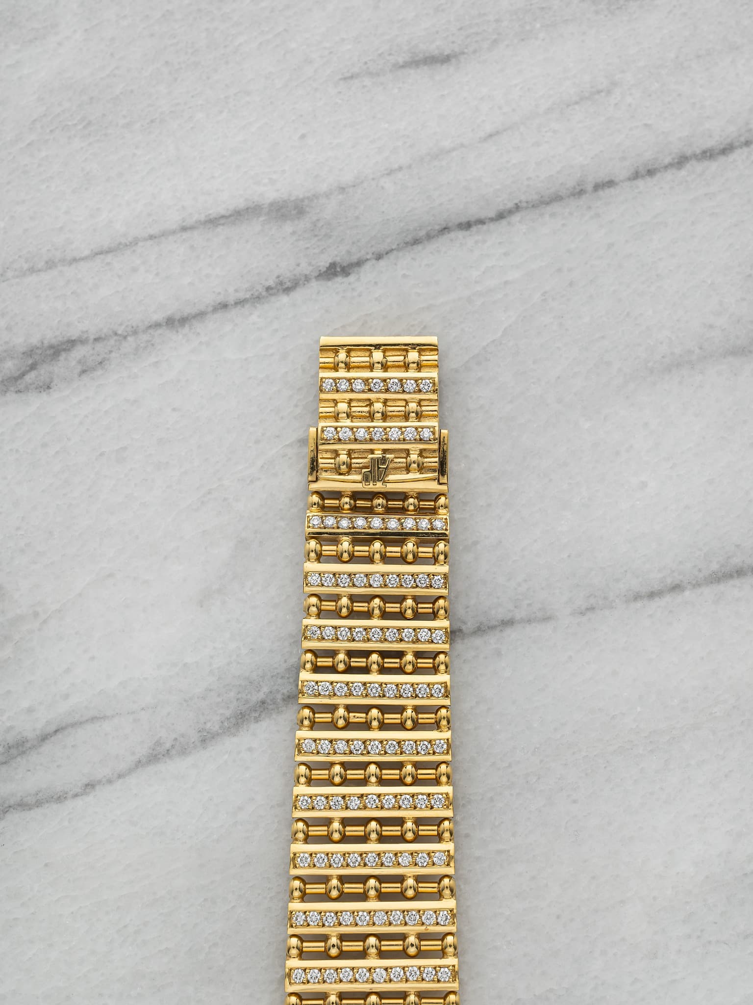 May be an image of brass, jewelry, wrist watch and text