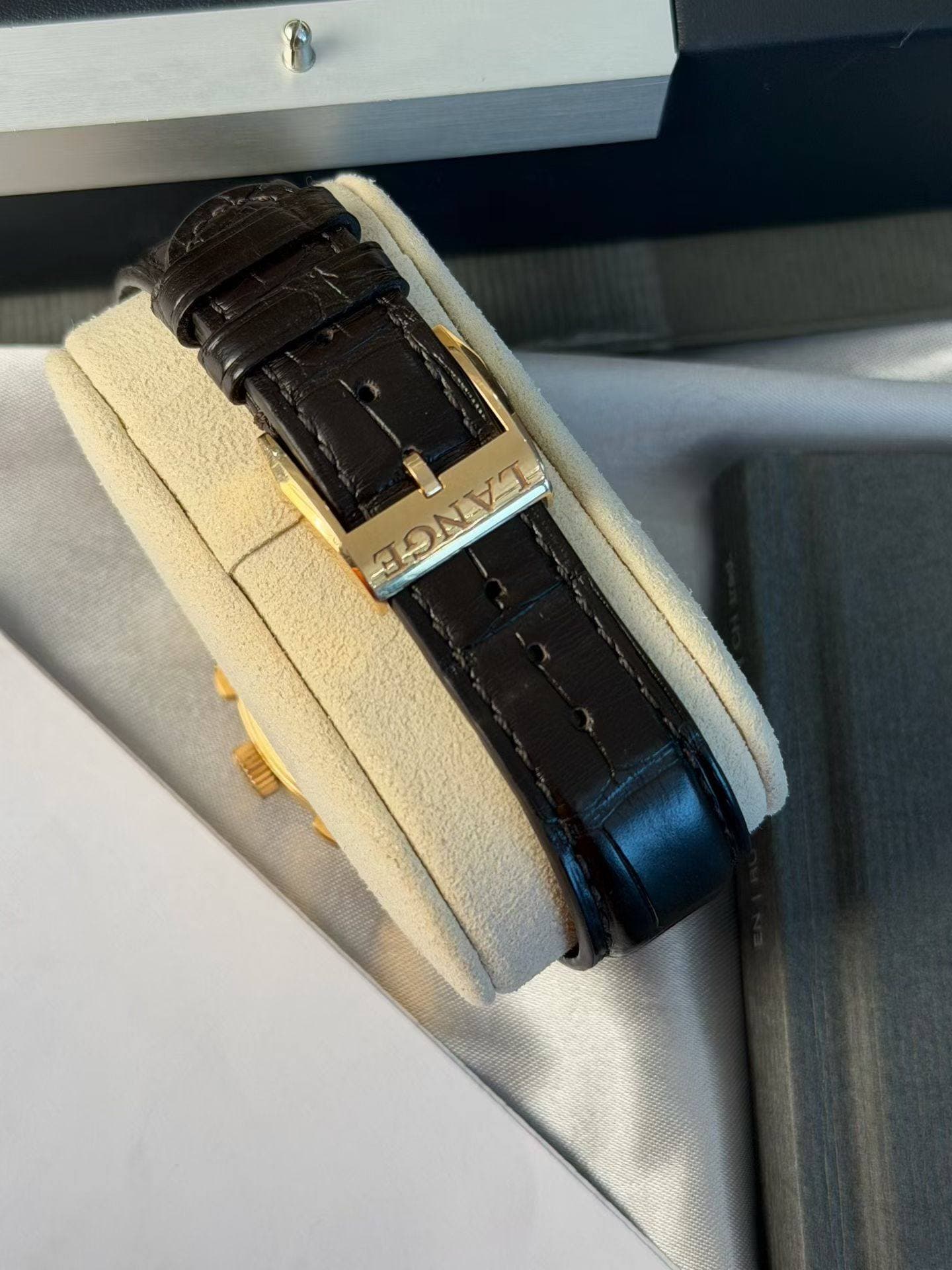 May be an image of wrist watch, leather and saddle-stitched leather